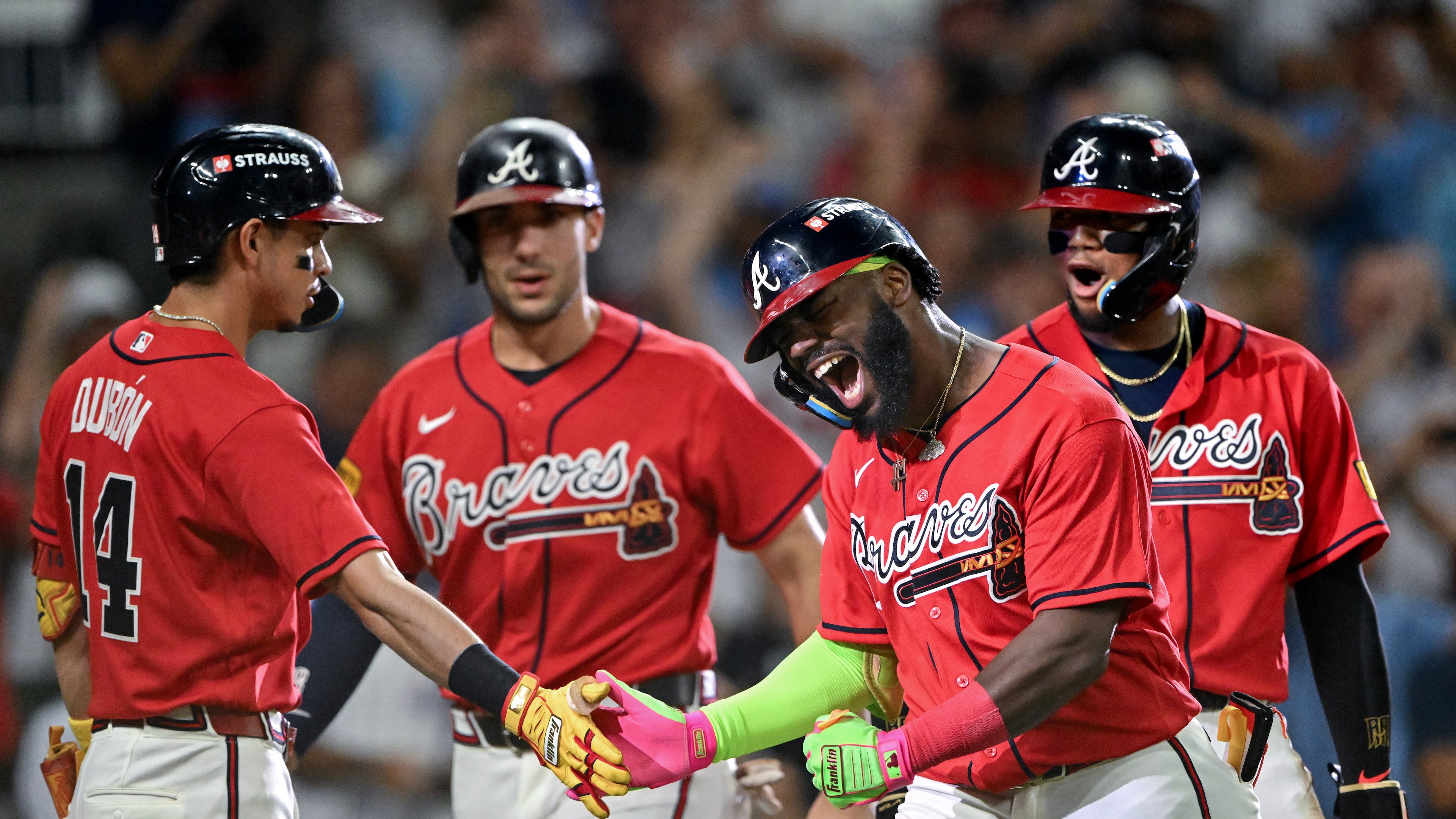 Braves outfielder Michael Harris II (second from right) reacts with Mauricio Dubón (left) and other teammates after hitting a three-run home run against the Phillies in the first inning of Game 3 of a National League Wild Card playoff series Thursday, Oct. 1, 2026, in Atlanta. (Hyosub Shin/AJC)