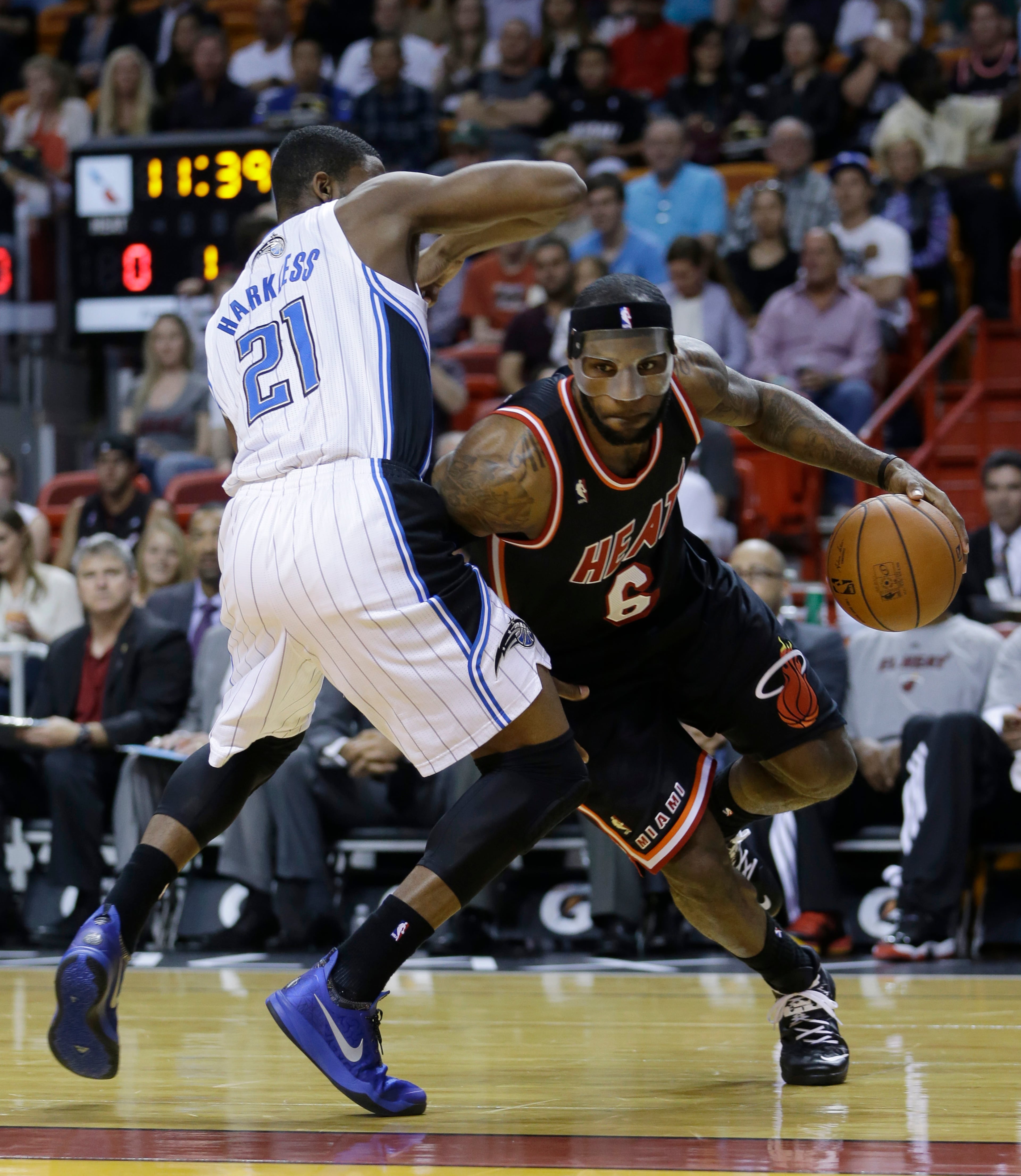 James wore a clear mask Saturday night. In this photo, James (6) drives around Orlando Magic small forward Maurice Harkless (21).