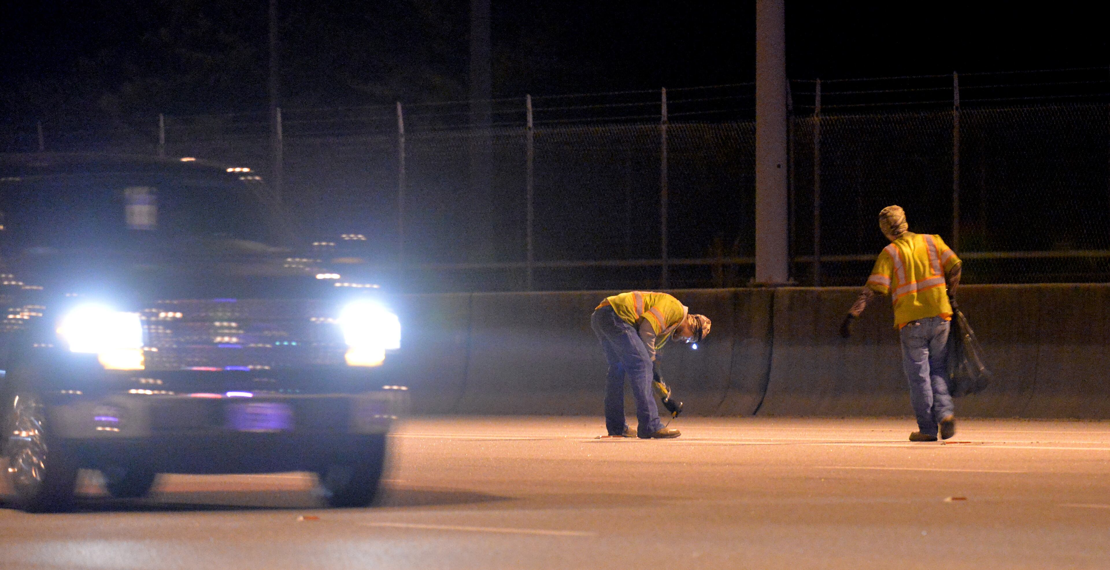 Road crews work as Georgia Department of Transportation closes two northbound lanes near Georgia 400 toll booths on Friday, October 25, 2013. The first phase of a four-phase demolition project began on Friday, October 25, 2013, with restriping in the Peach Pass electronic toll lanes and modification/removal of redundant signage. Phase I of the project will include the restriping in the electronic Peach Pass lanes and the start of the removal or modification of toll-related signage from areas approaching the GA 400 Toll Plaza within the next two to three weeks.