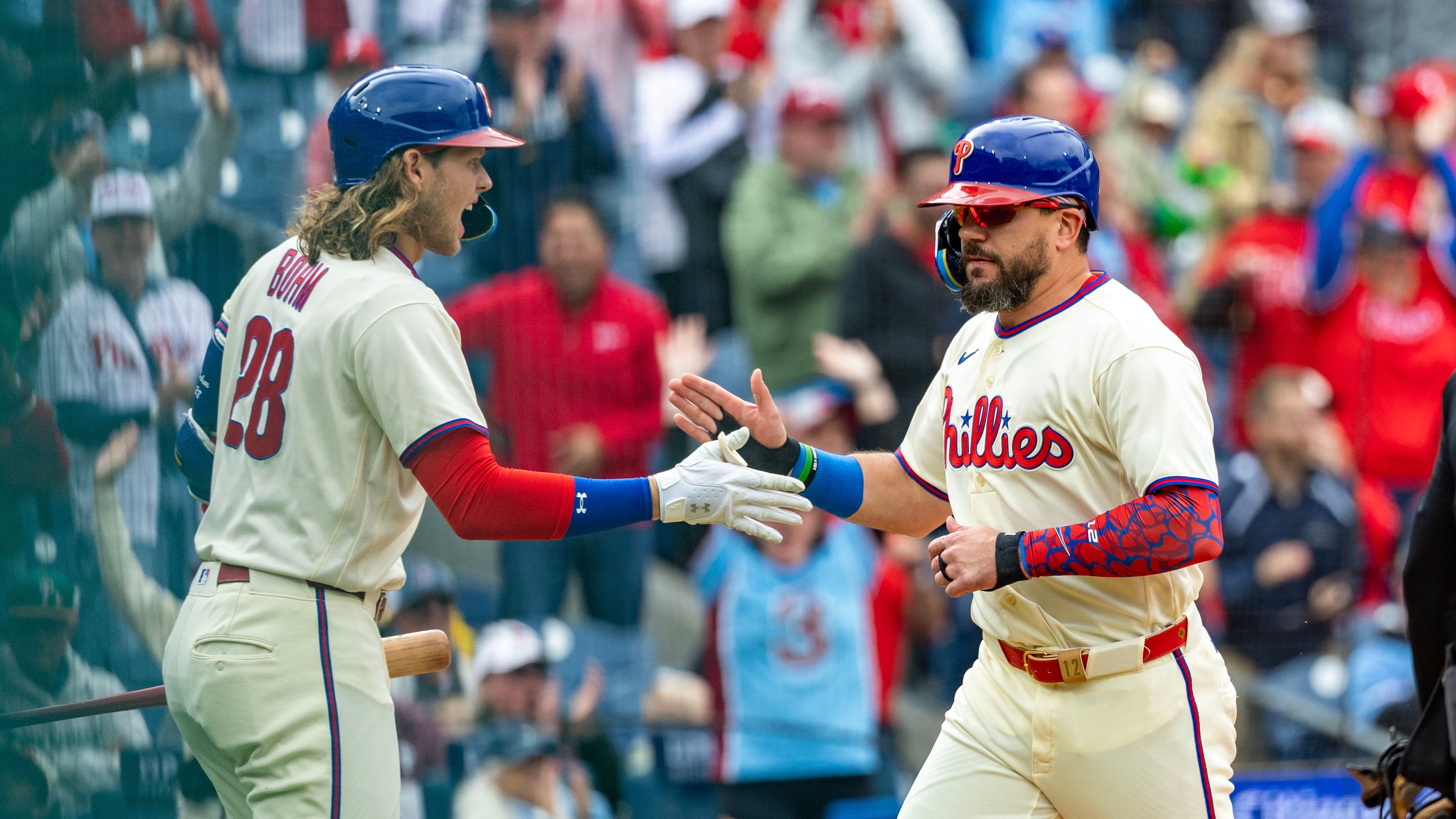 Philadelphia Phillies designated hitter Kyle Schwarber, right, is cheered by Alec Bohm, left, after scoring on an RBI double by Bryson Stott during the first inning of a baseball game against the Tampa Bay Rays, Sunday, Sept. 27, 2026, in Philadelphia. (AP Photo/Laurence Kesterson)
