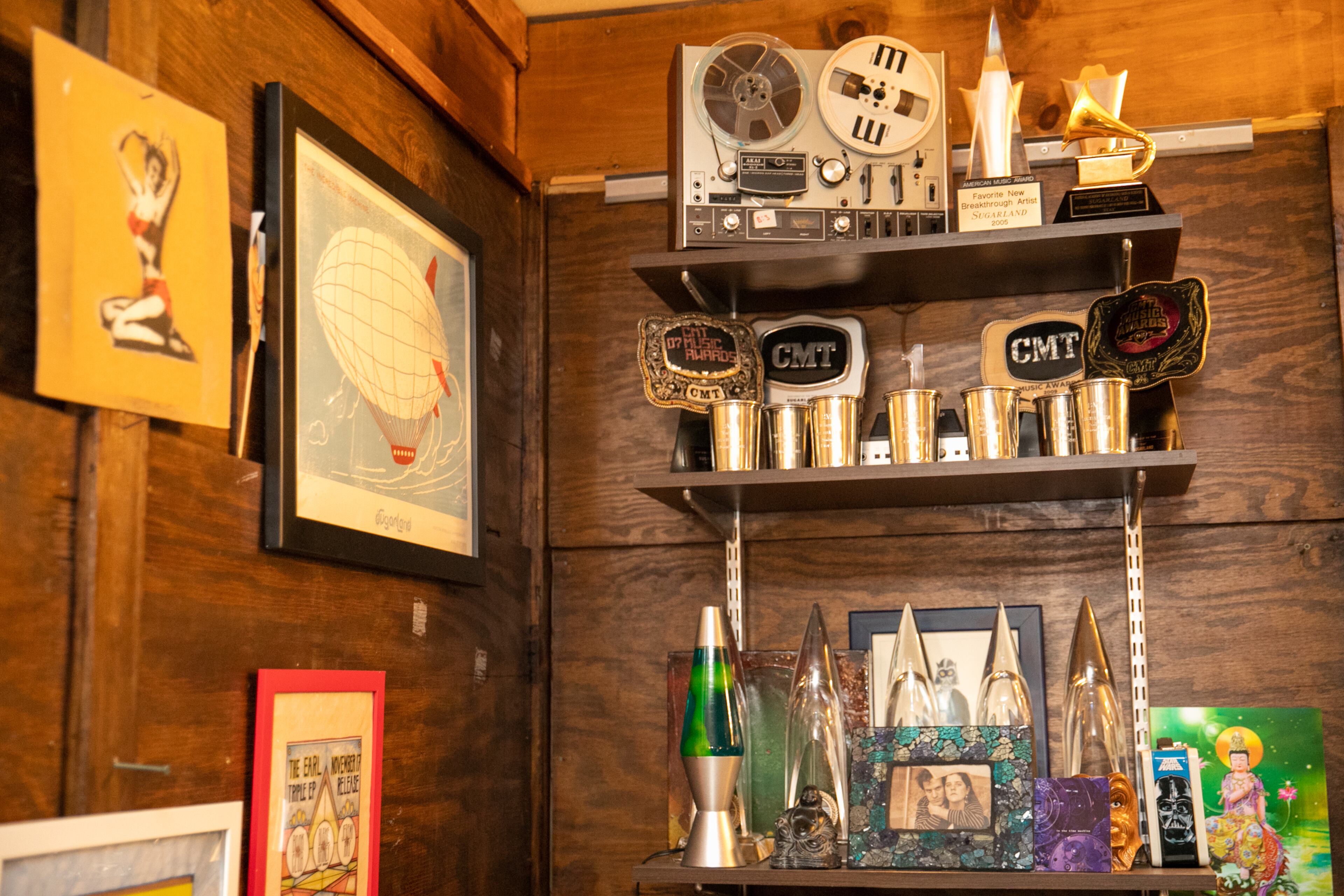 One of his Grammy awards, several ACM awards and a few CMT awards are mixed in with vintage lunchboxes and personal photos in Kristian Bush’s Decatur studio where he reflects on decades in the music business Wednesday, March 16, 2022. The release of his newest album "52,” made in conjunction with his 52nd birthday, continues to blur the lines of country, rock and R&B with the first of the 4-part album releasing in March and the second part in summer. (Jenni Girtman for The Atlanta Journal-Constitution)