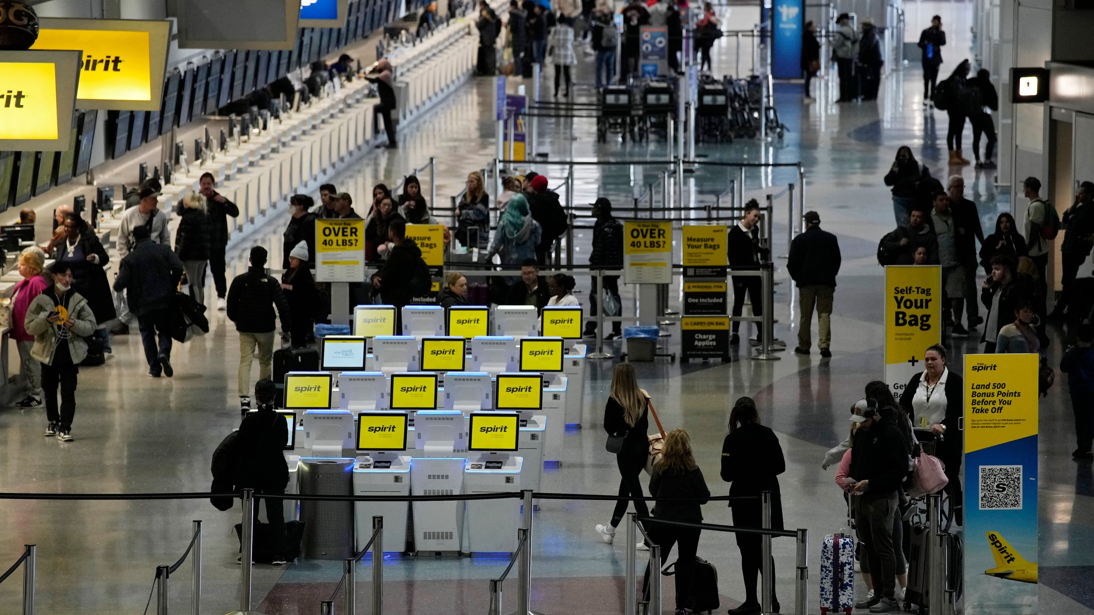 FILE - People check into their flights at Harry Reid International Airport, Jan. 11, 2023, in Las Vegas. (AP Photo/John Locher, File)