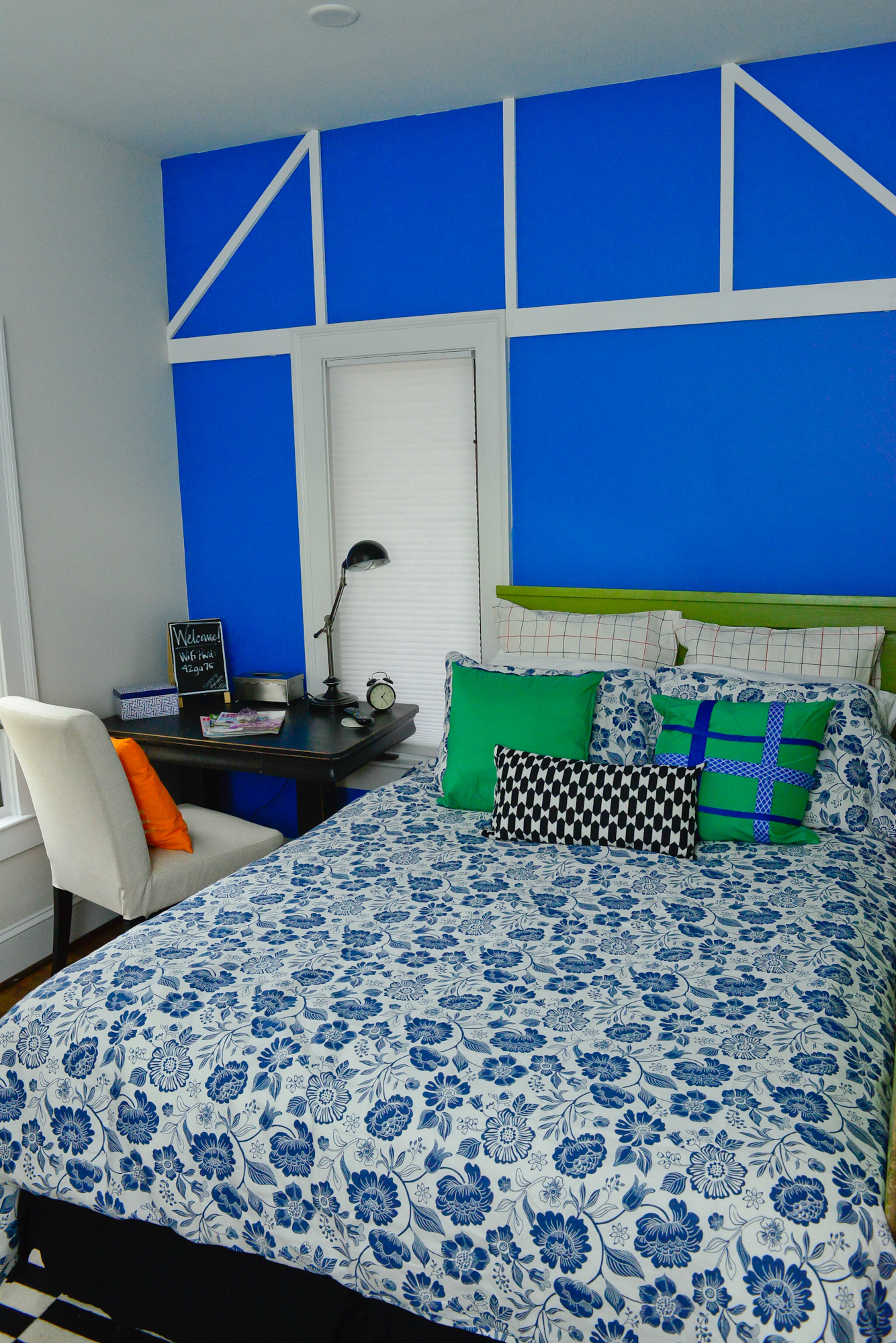 The guest room, which doubles as a music room, features a desk from Finders Keepers Furnishings, an accent wall painted Benjamin Moore's Brilliant Blue and bedding from IKEA and HomeGoods.