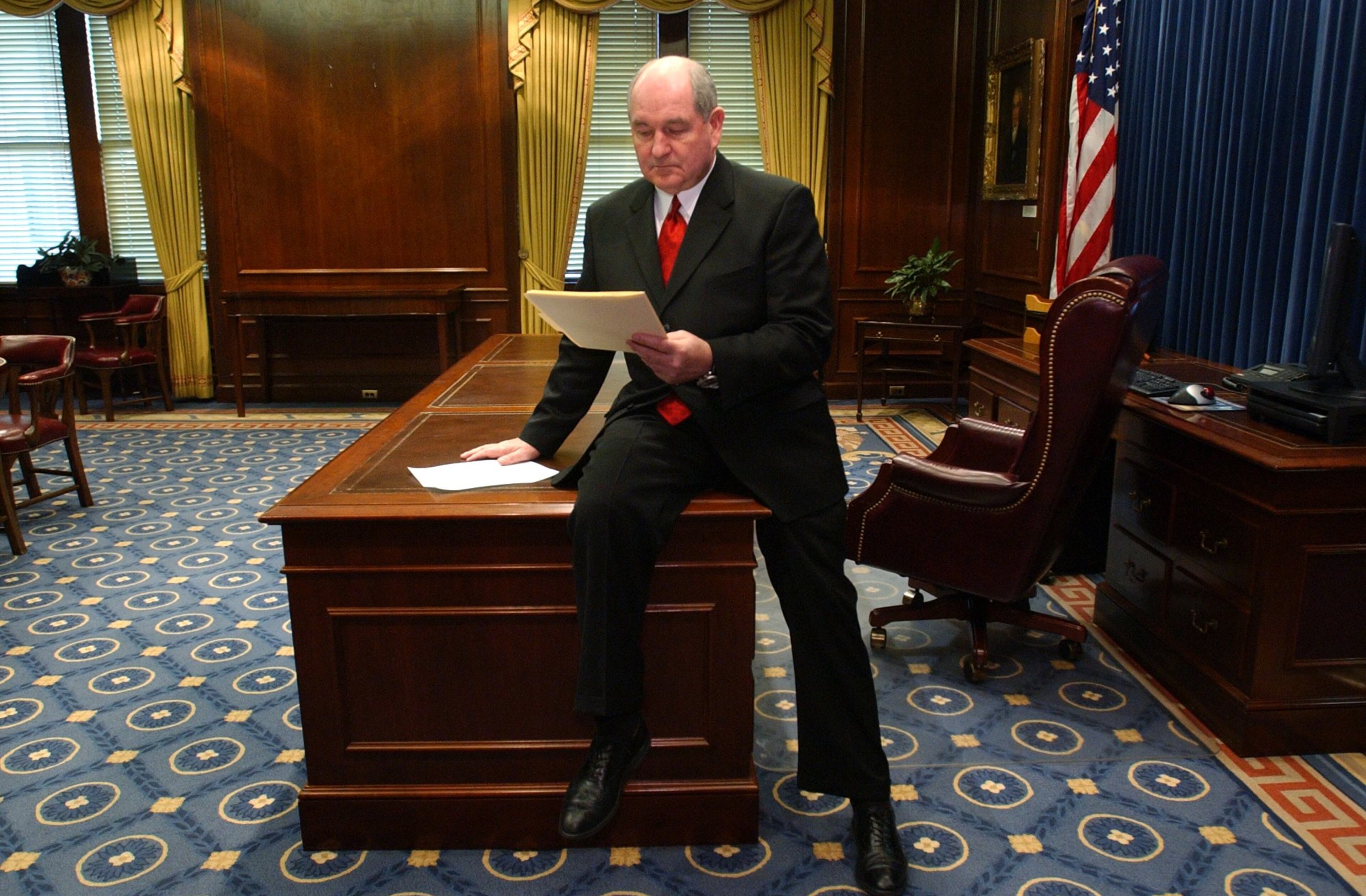 In this 2003 file photo, Gov. Sonny Perdue does his first official business as Georgia's new governor by reviewing some executive orders (which he signed later in the Senate chamber) in his new office at the Capitol. After his inauguration ceremony at Philips, Perdue rode by car halfway to the Capitol and then walked the final distance with his wife, Mary. RICH ADDICKS/STAFF