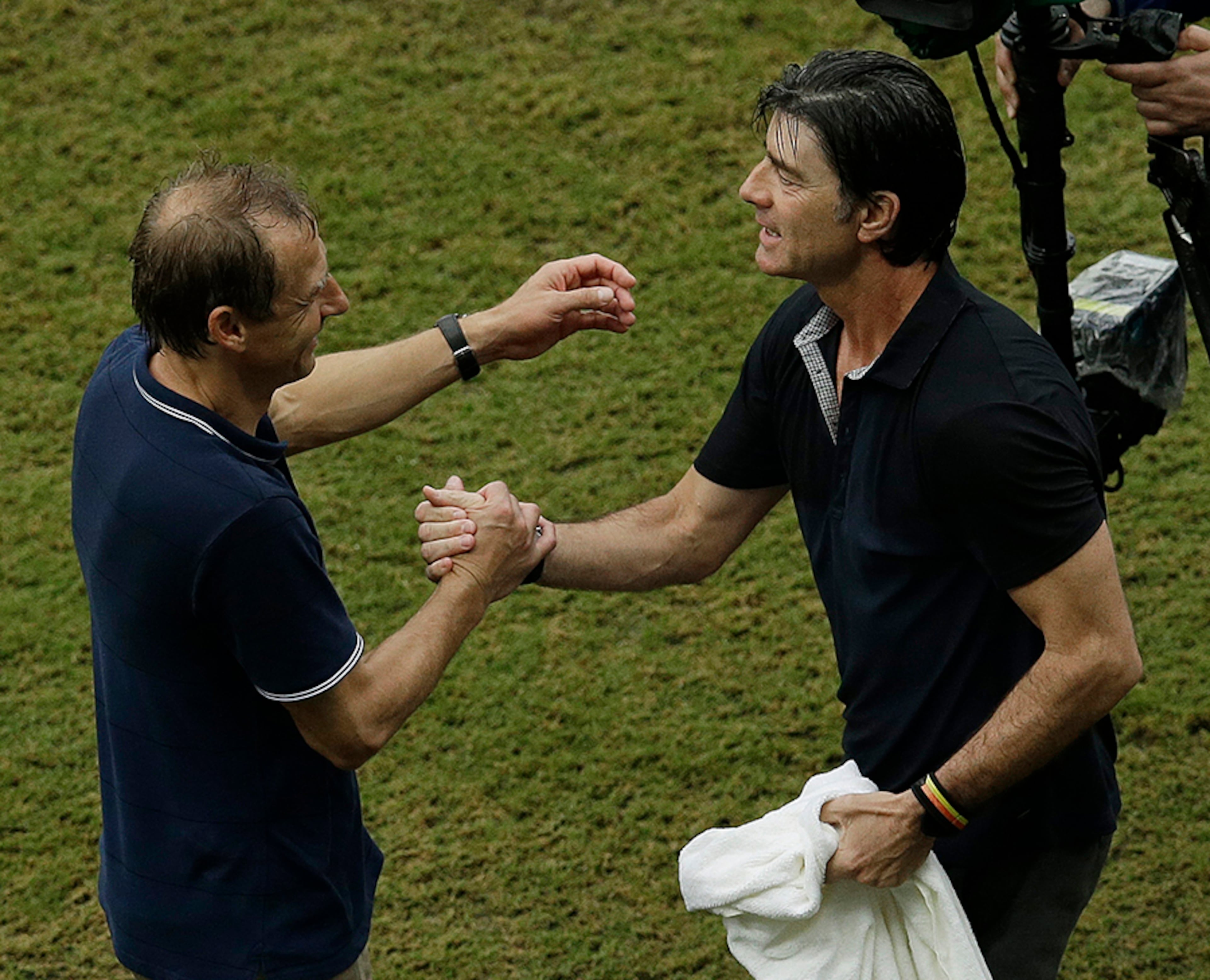 United States' head coach Juergen Klinsmann (left) and Germany's head coach Joachim Loew greet each other after Germany's 1-0 win at the Arena Pernambuco in Recife, Brazil, Thursday, June 26, 2014. Klingsmann played for Germany's national team.