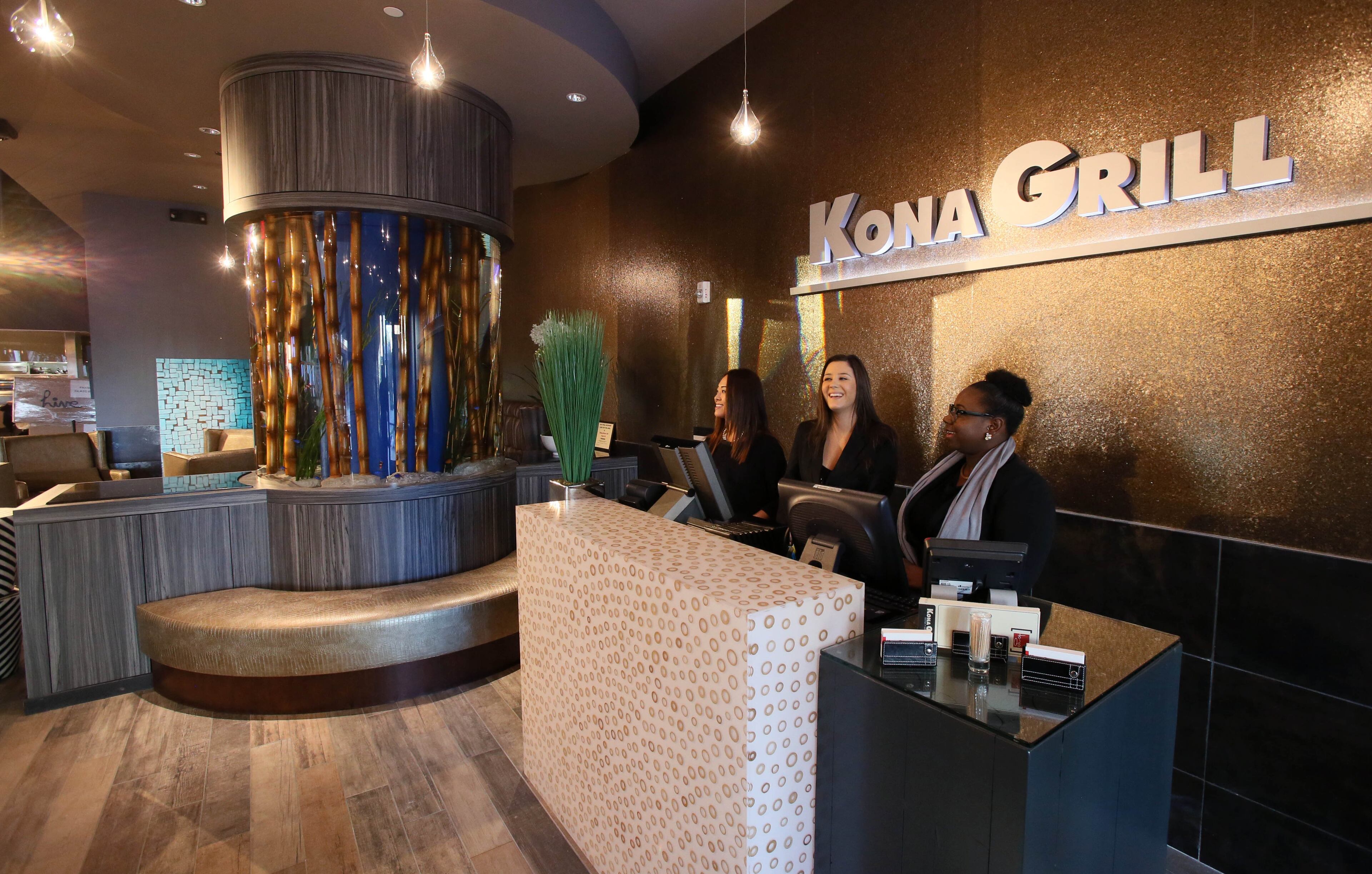 Mindy Cox (left), Paige Frydrych, and Ashley Cooper attend the hostess stand at Kona Grill.