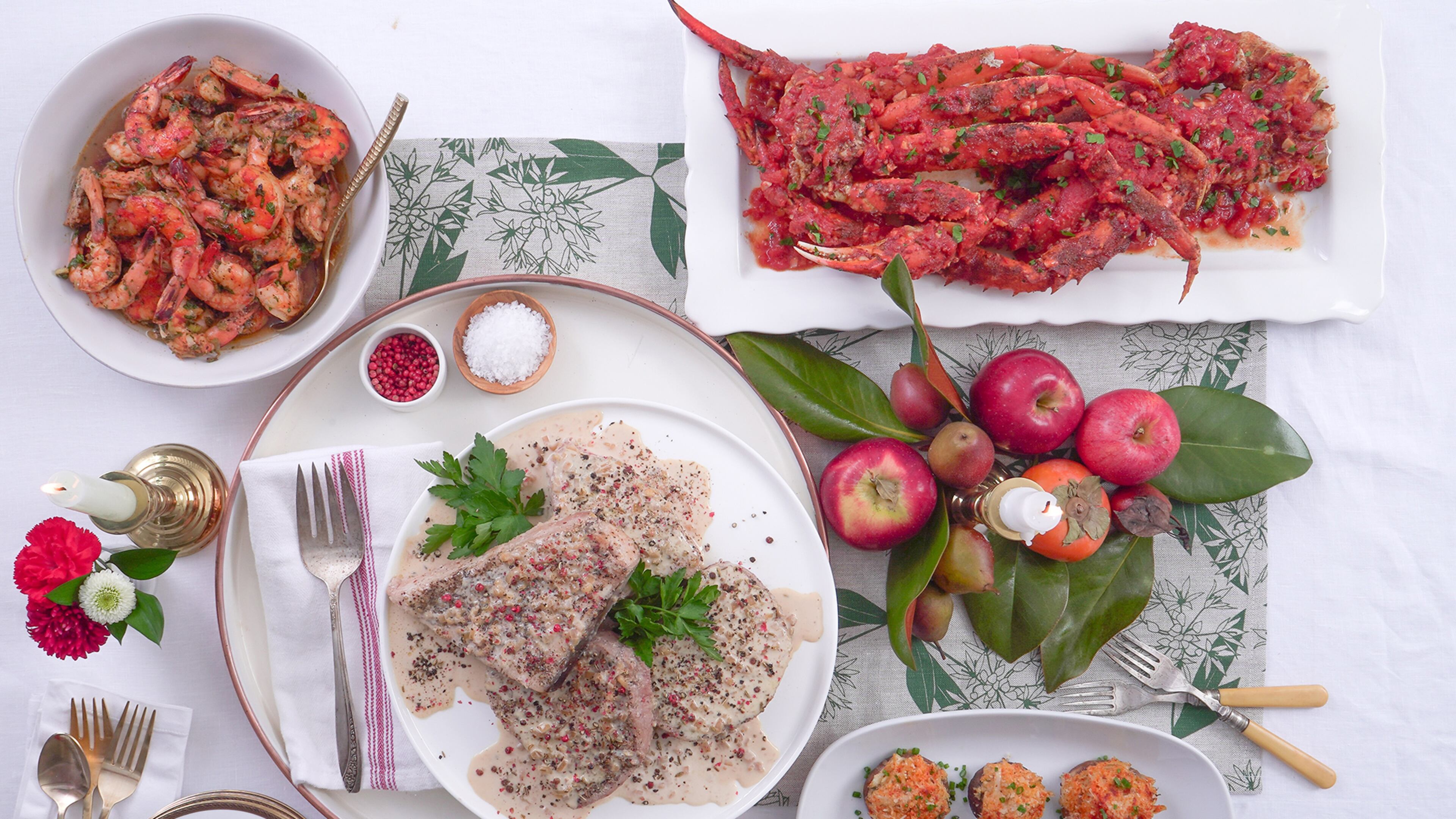 Making smart choices at the fish counter can make this year’s holiday seafood dishes, like Swordfish Au Poivre (center), Baked Honey Ginger Shrimp (top left), Crab Legs with Spicy Garlic Tomato Sauce (top right) and Crab Stuffed Mushrooms (bottom left), impressive and reasonably affordable. (Chadwick Boyd for The Atlanta Journal-Constitution)