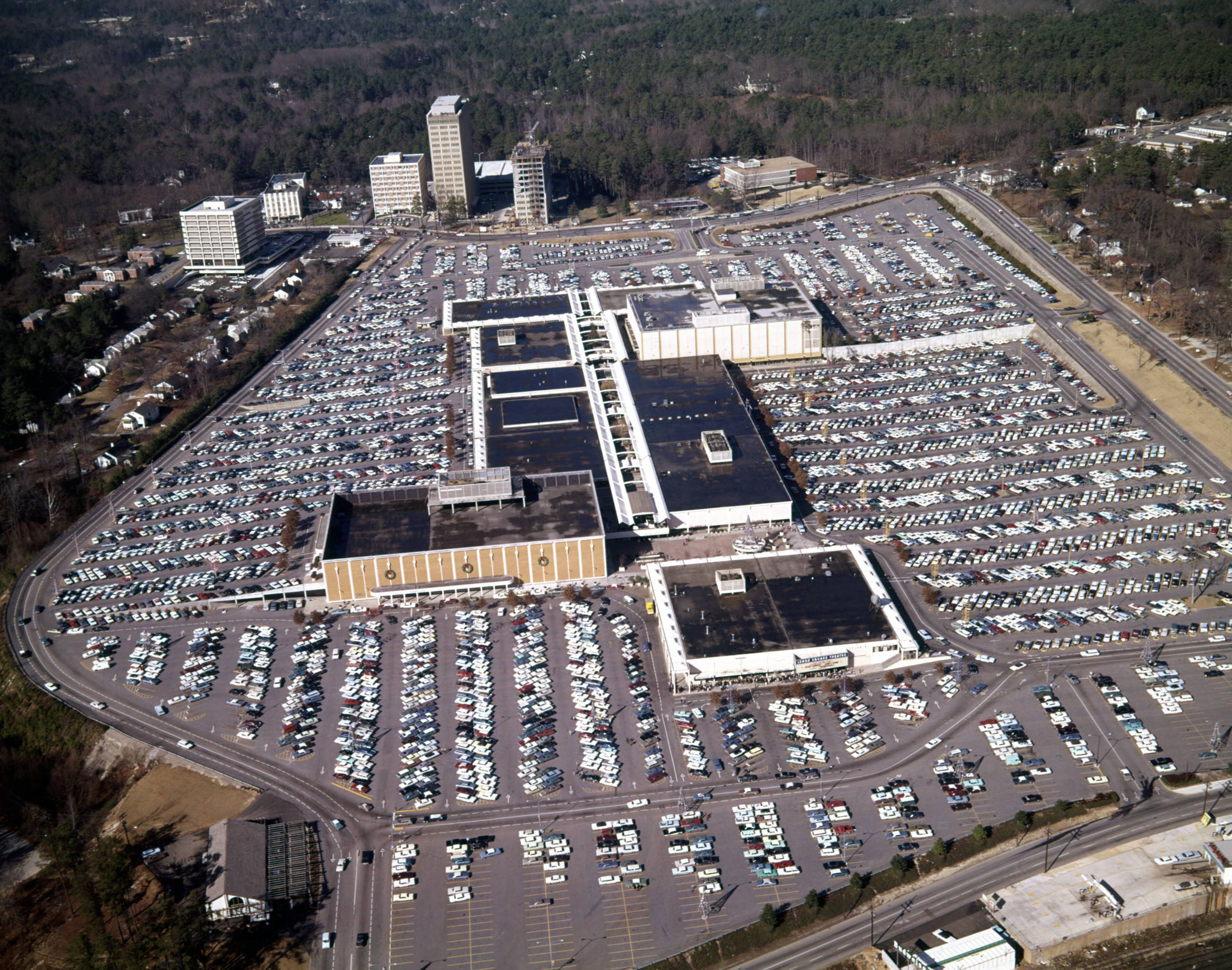 Aerial view of Lenox Square and its surrounding parking lot; Lenox Square Theatre in the foreground, looking northeast, Buckhead, Atlanta, Georgia, December 21, 1965.