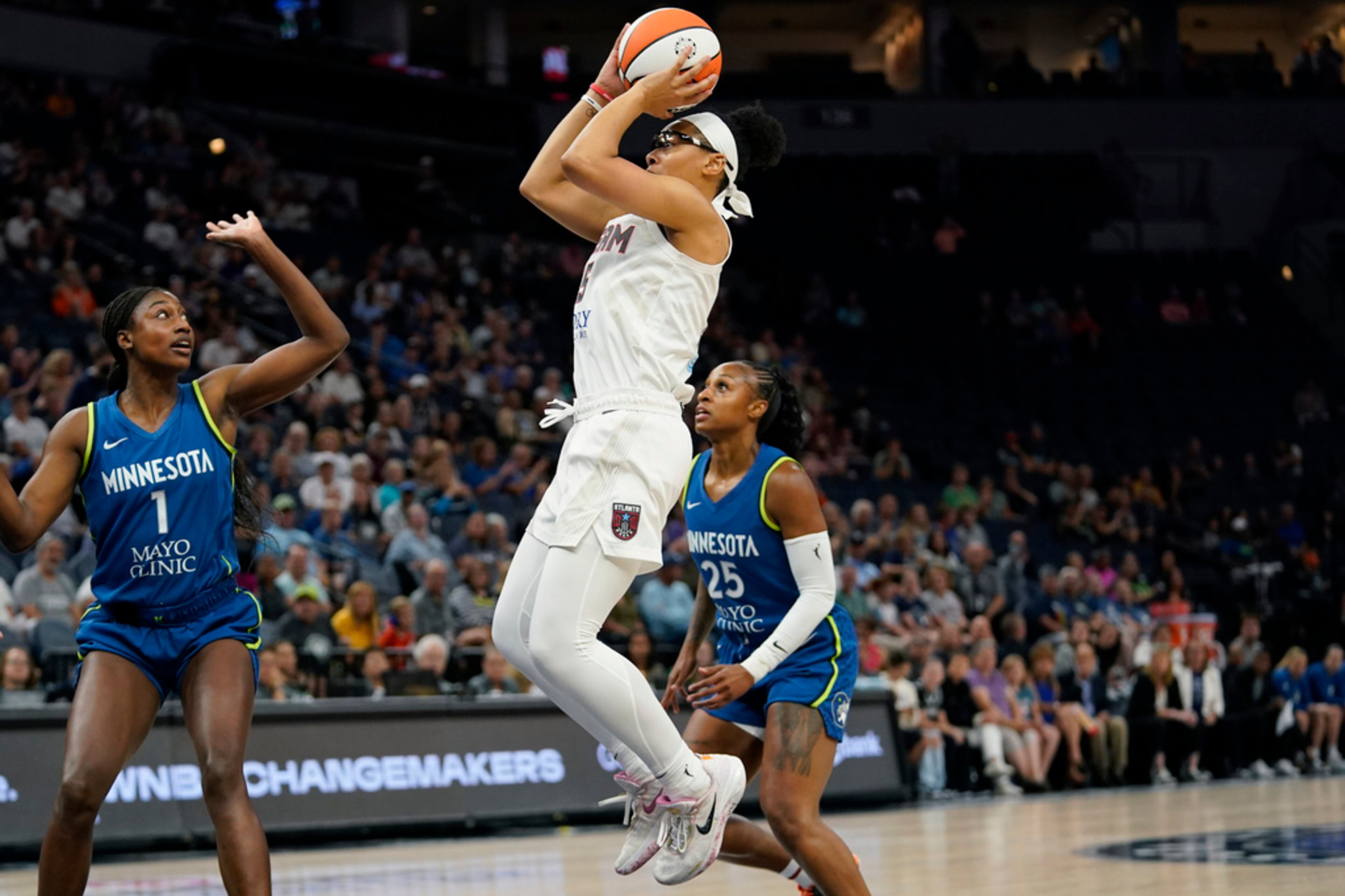 Atlanta Dream guard Allisha Gray, center, shoots during the first half of a WNBA basketball game against the Minnesota Lynx, Friday, Sept. 1, 2023, in Minneapolis. (AP Photo/Abbie Parr)