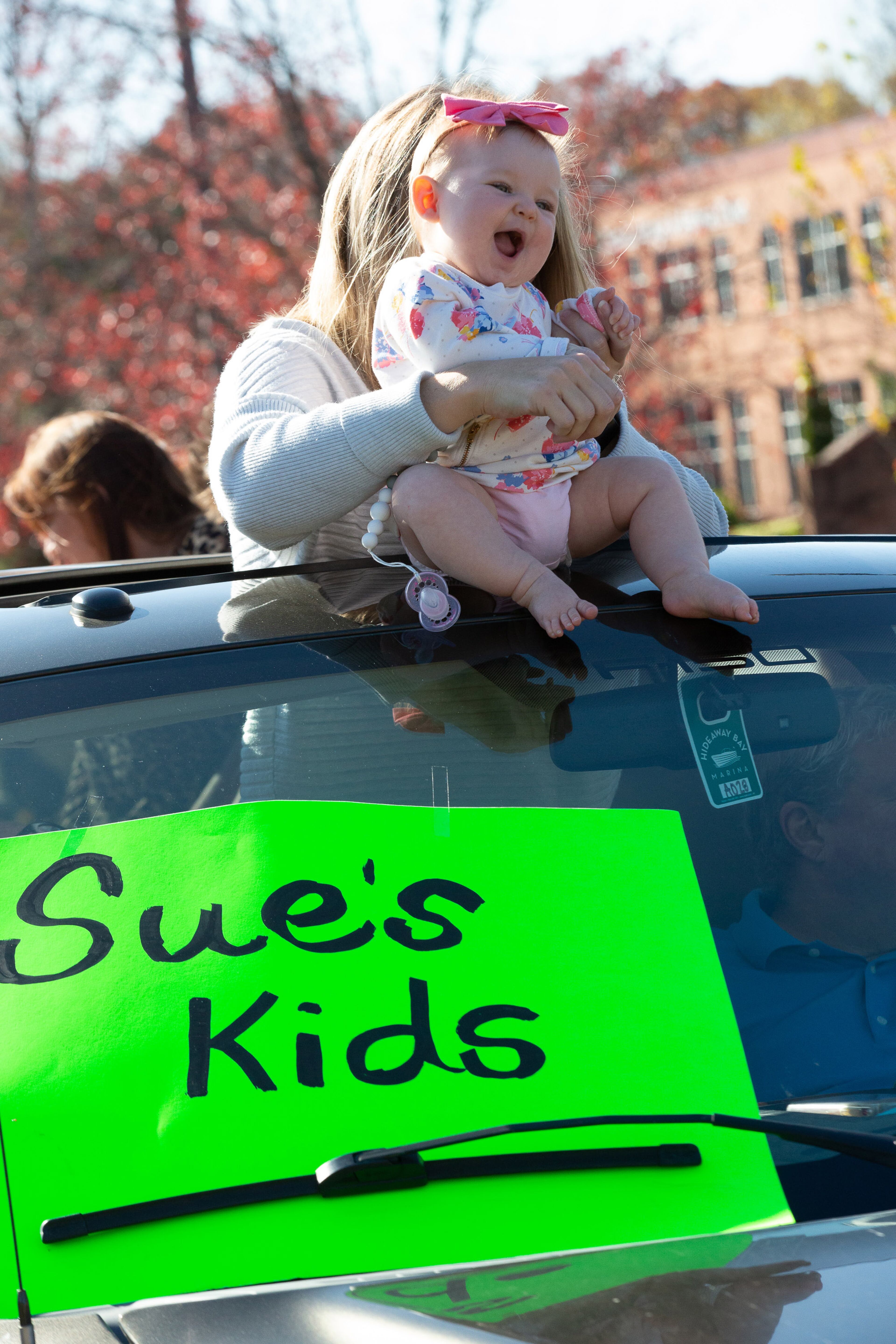 Susanna Couvillon holds her daughter Saillor as they get ready for the Thanksgiving Day outdoor parade at the assisted living home Oaks at Douglasville on Thursday, November 26, 2020. (Photo: Steve Schaefer for The Atlanta Journal-Constitution)