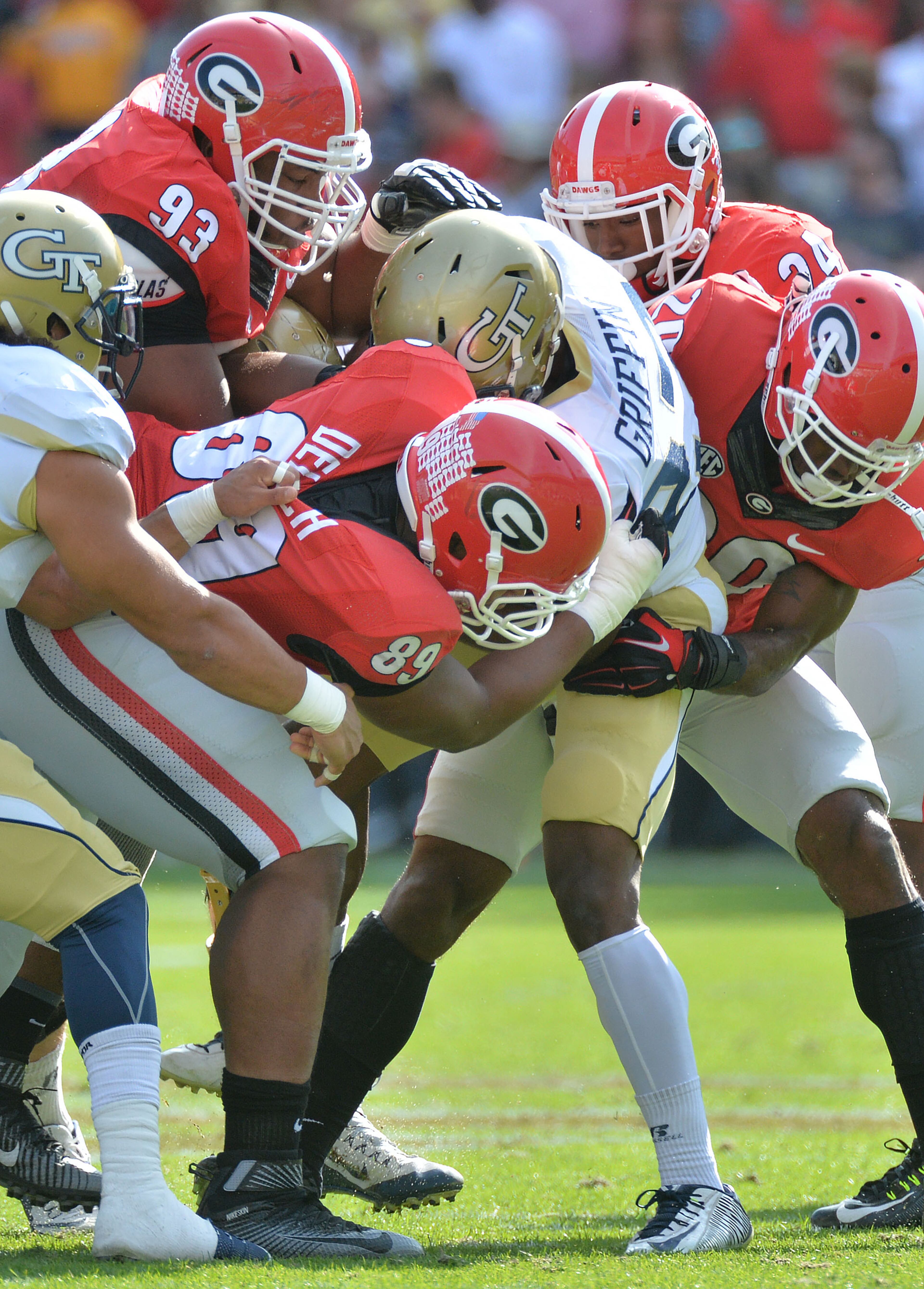 November 28, 2015 Atlanta - Georgia Tech Yellow Jackets defensive back Lynn Griffin (27) is taken by Georgia Bulldogs defenders in the first half at Bobby Dodd Stadium on Saturday, November 28, 2015. HYOSUB SHIN / HSHIN@AJC.COM