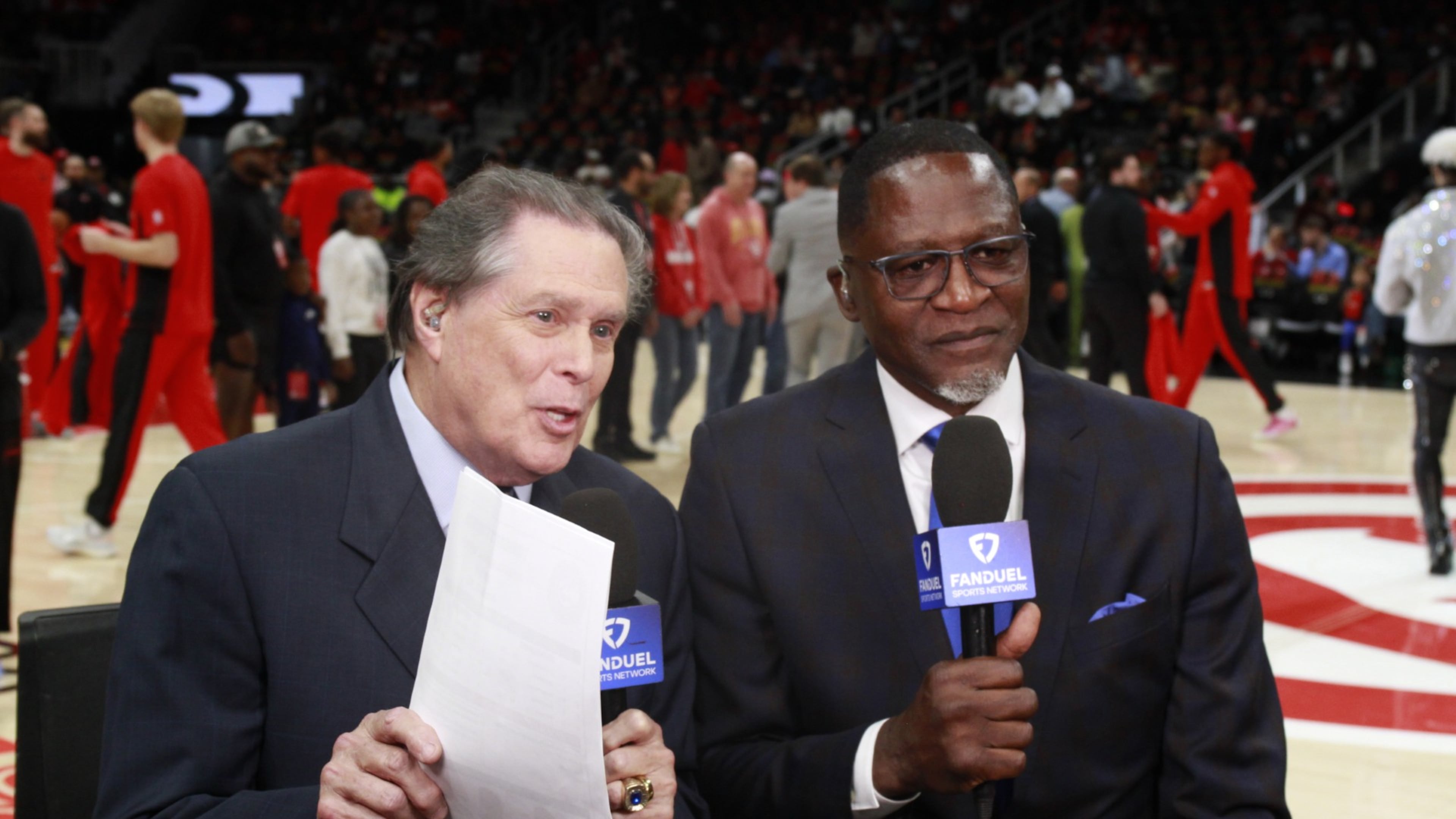 Bob Rathbun (left), joined here by Hawks icon Dominique Wilkins, has been a fixture as the Hawks' TV play-by-play announcer for 30 years. (Courtesy of FanDuel Sports Network)