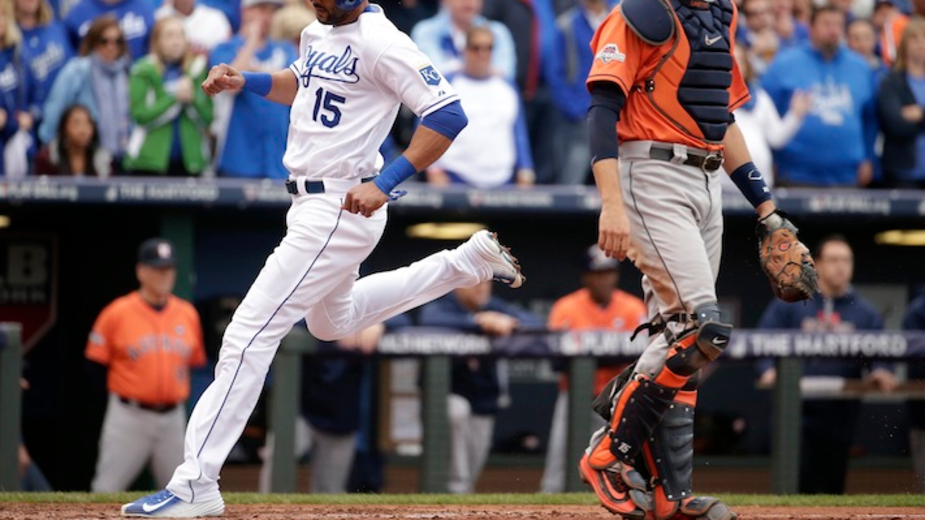 Kansas City Royals' Alex Rios, left, scores a run in front of Houston Astros catcher Jason Castro during the third inning of Game 2 in baseball's American League Division Series, Friday, Oct. 9, 2015, in Kansas City, Mo. (AP Photo/Charlie Riedel)