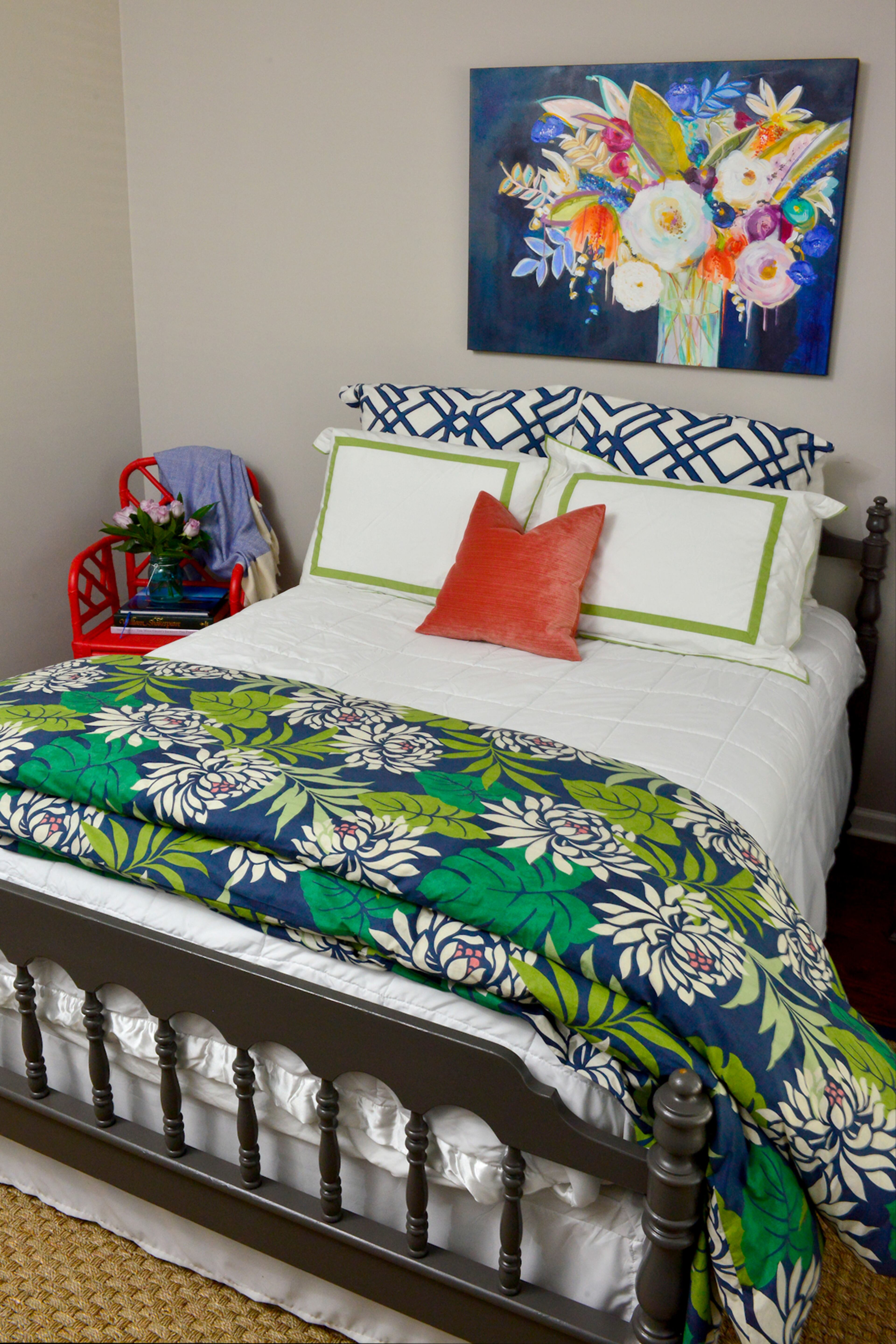 Bedding from Pottery Barn, repainted furniture and a floral painting by local artist Tamara Gleason create a colorful focus in the guest bedroom. The neutral walls are painted in Alpaca by Sherwin-Williams. Text by Lori Johnston and Keith Still/Fast Copy News Service.