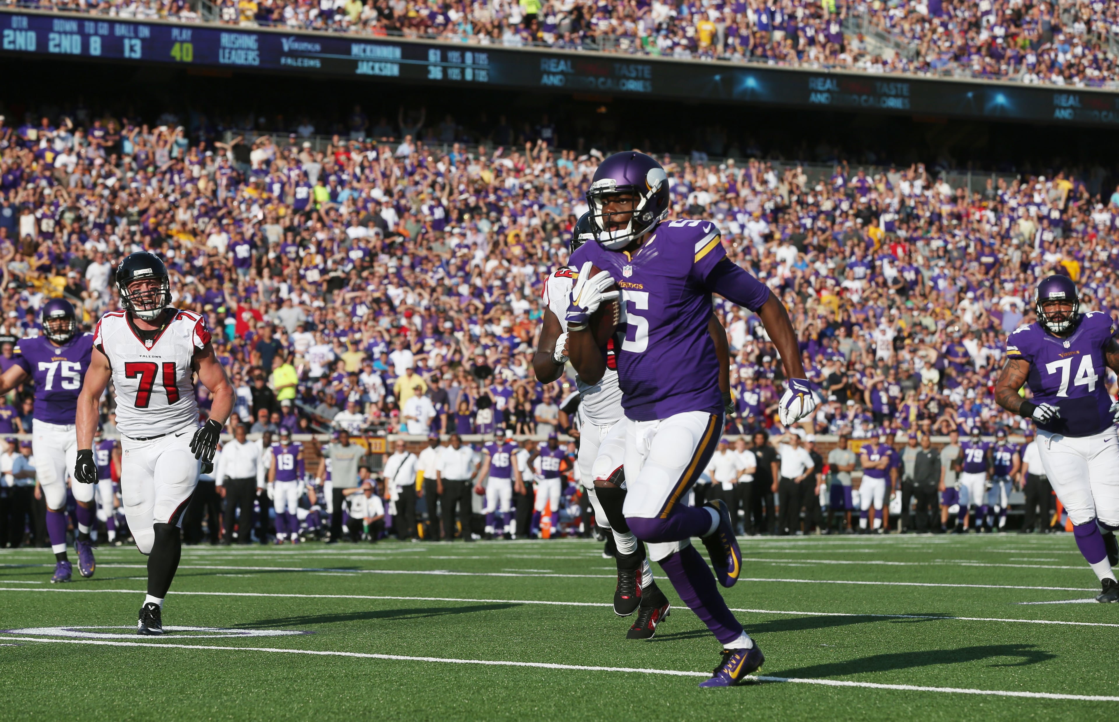Minnesota Vikings quarterback Teddy Bridgewater (5) scrambles for a 13-yard touchdown during the first half of an NFL football game against the Atlanta Falcons, Sunday, Sept. 28, 2014, in Minneapolis. (AP Photo/Jim Mone)