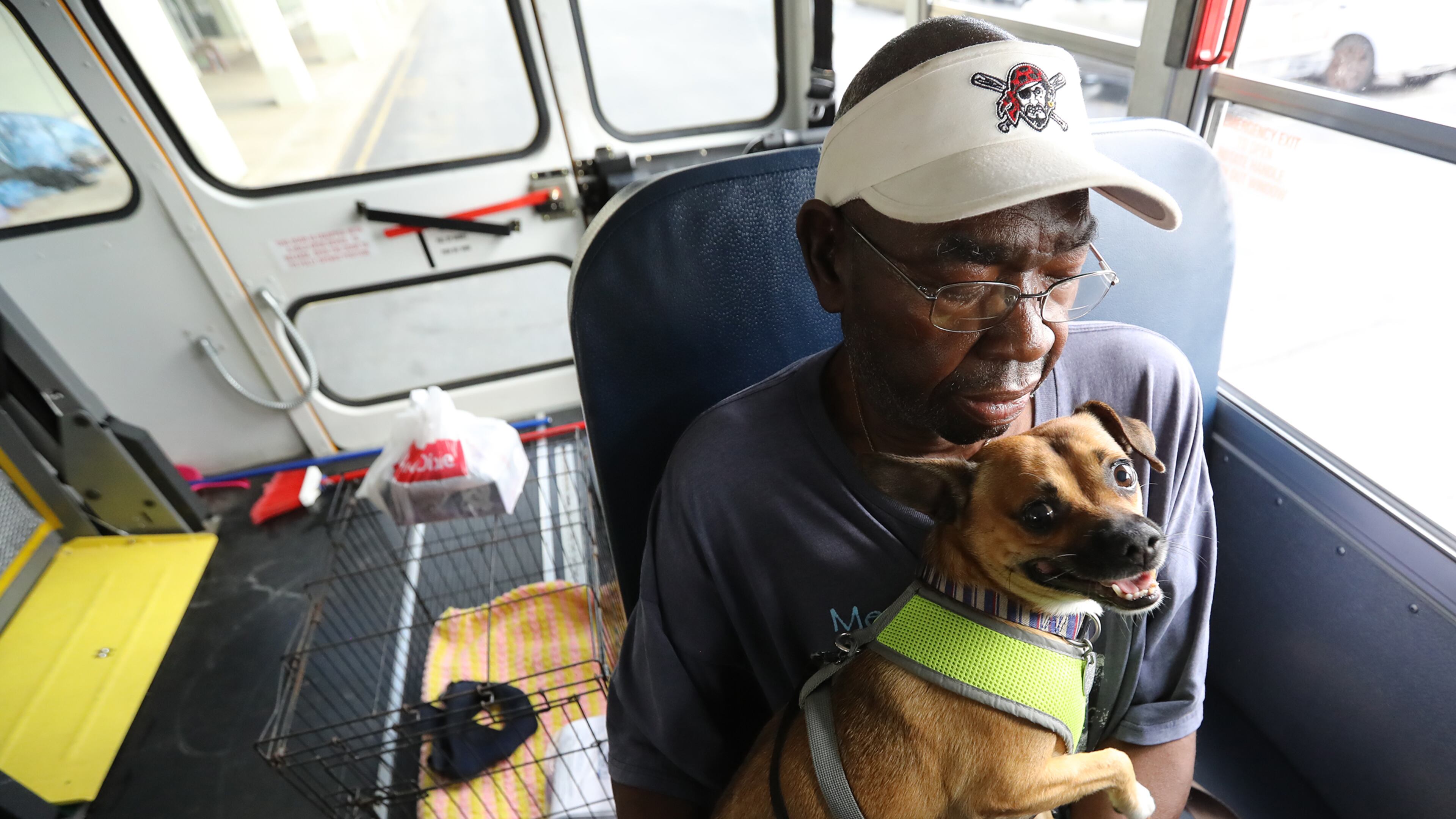 Brunswick resident Eddie Wright, 68, and his dog Vino wait Tuesday on one of the final buses at Lanier Plaza in the coastal city to evacuate from Hurricane Dorian to Columbus. Curtis Compton/ccompton@ajc.com