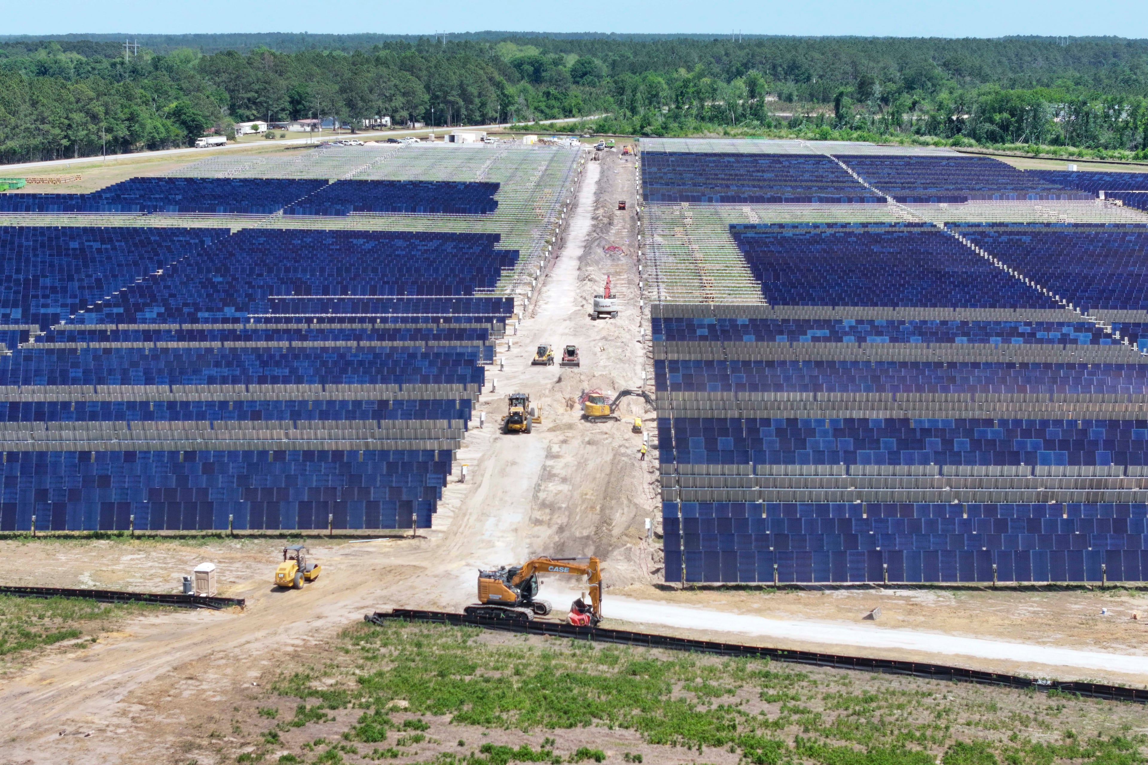 An aerial image depicts multiple heavy machinery working on a large site in Bacon County, where Silicon Ranch is constructing one of Georgia’s largest solar farms, in one of the state’s smallest counties, on Tuesday, April 21, 2026. The project faces opposition from residents and farmers, who say it is altering their way of life. (Miguel Martinez/AJC)