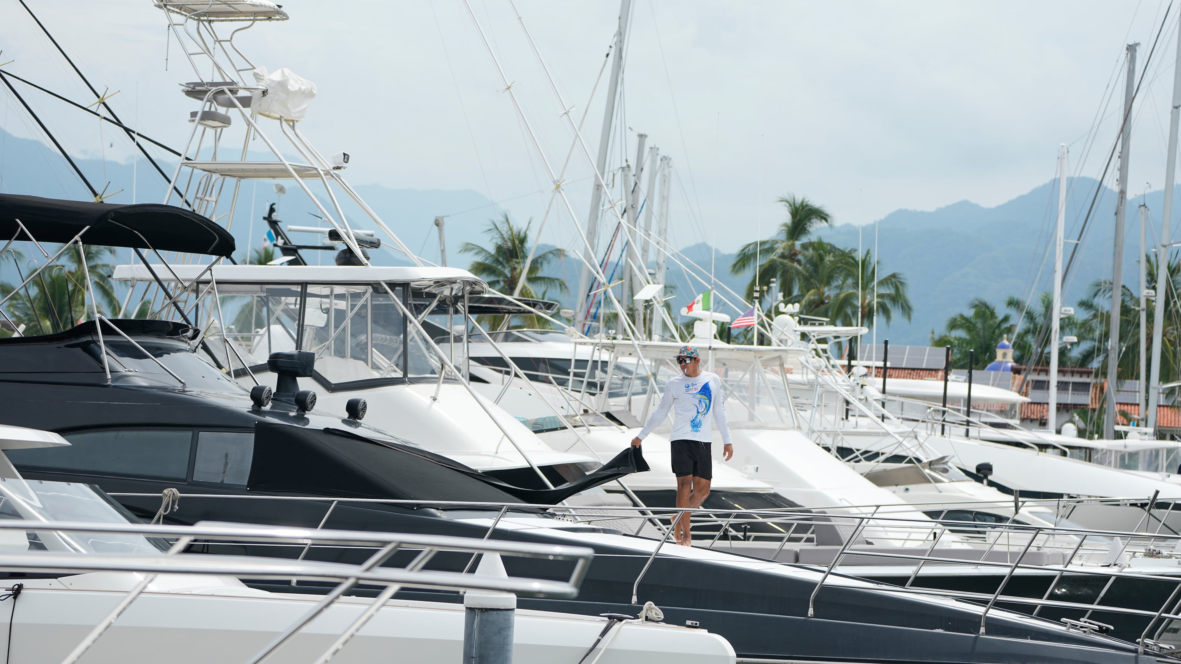 A man places a window covering on his boat as Hurricane Simon approaches Puerto Vallarta, Mexico, Saturday, Oct. 10, 2026. (AP Photo/Fernando Llano)