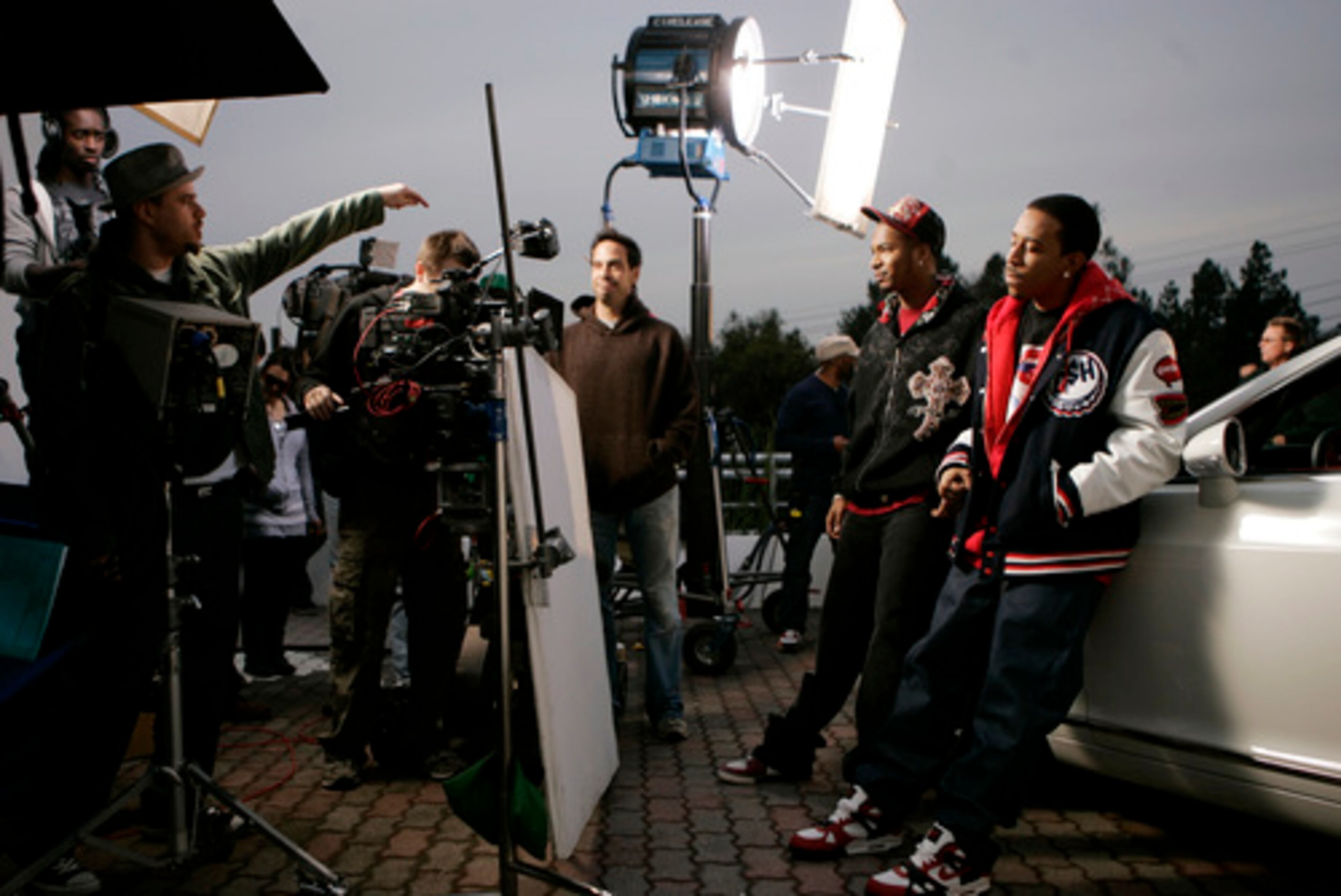 Syndrome, left, directs Chingy (second from right) and Ludacris (right) at the video shoot.