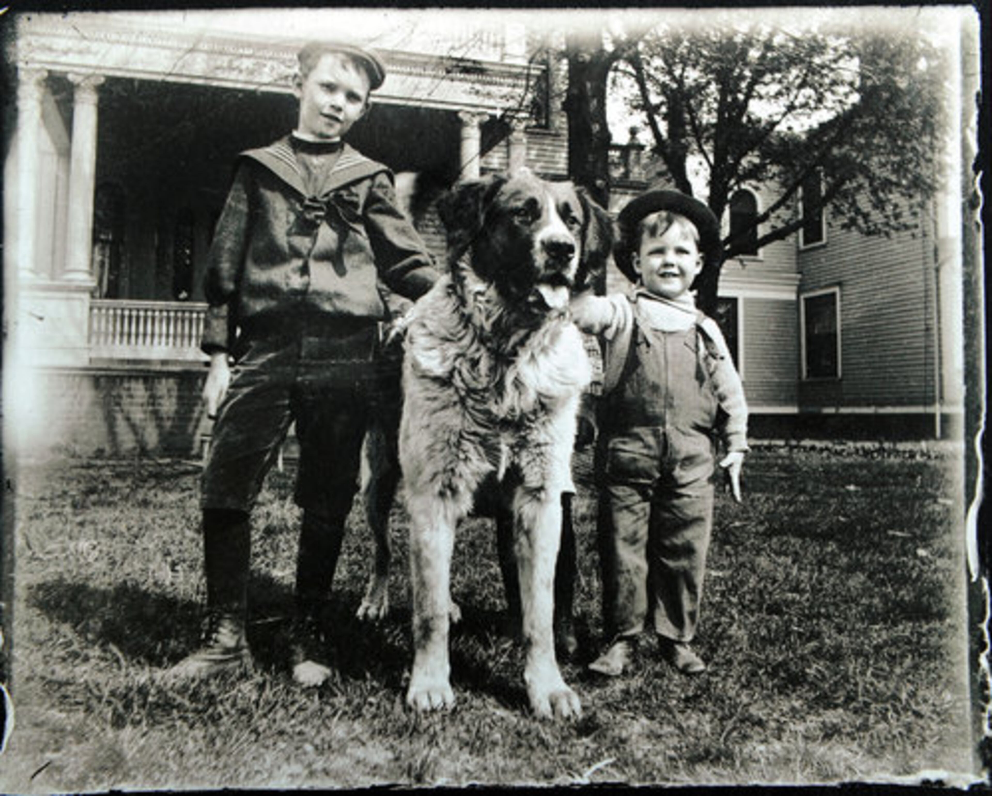 The Nicholson children with their dog in front of their home in the early 1890's.