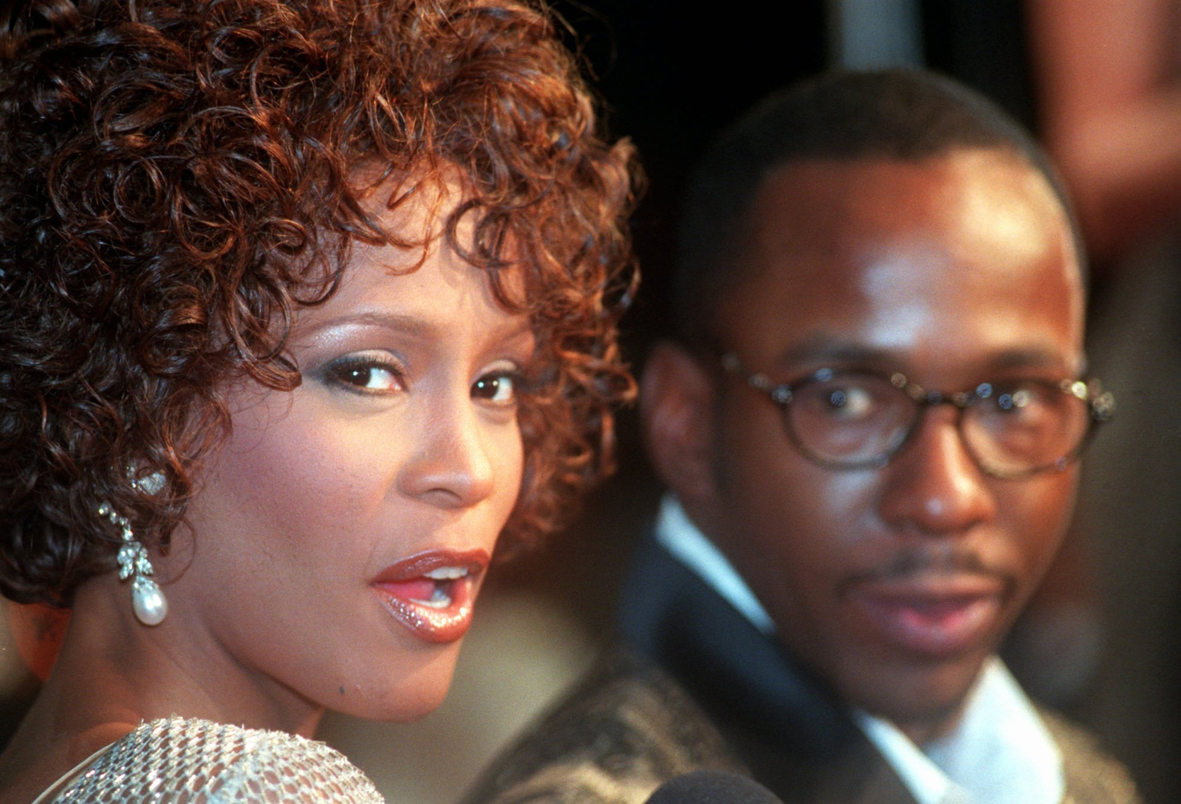 Whitney Houston looks over her shoulder as her husband Bobby Brown looks to her at the premiere of "The Wonderful World of Disney" movie "Cinderella," at Mann's Chinese Theater in the Hollywood section of Los Angeles, Whitney Houston, who reigned as pop music's queen until her majestic voice and regal image were ravaged by drug use, has died, Saturday, Feb. 11, 2012. She was 48. (AP Photo/Rene Macura, File)