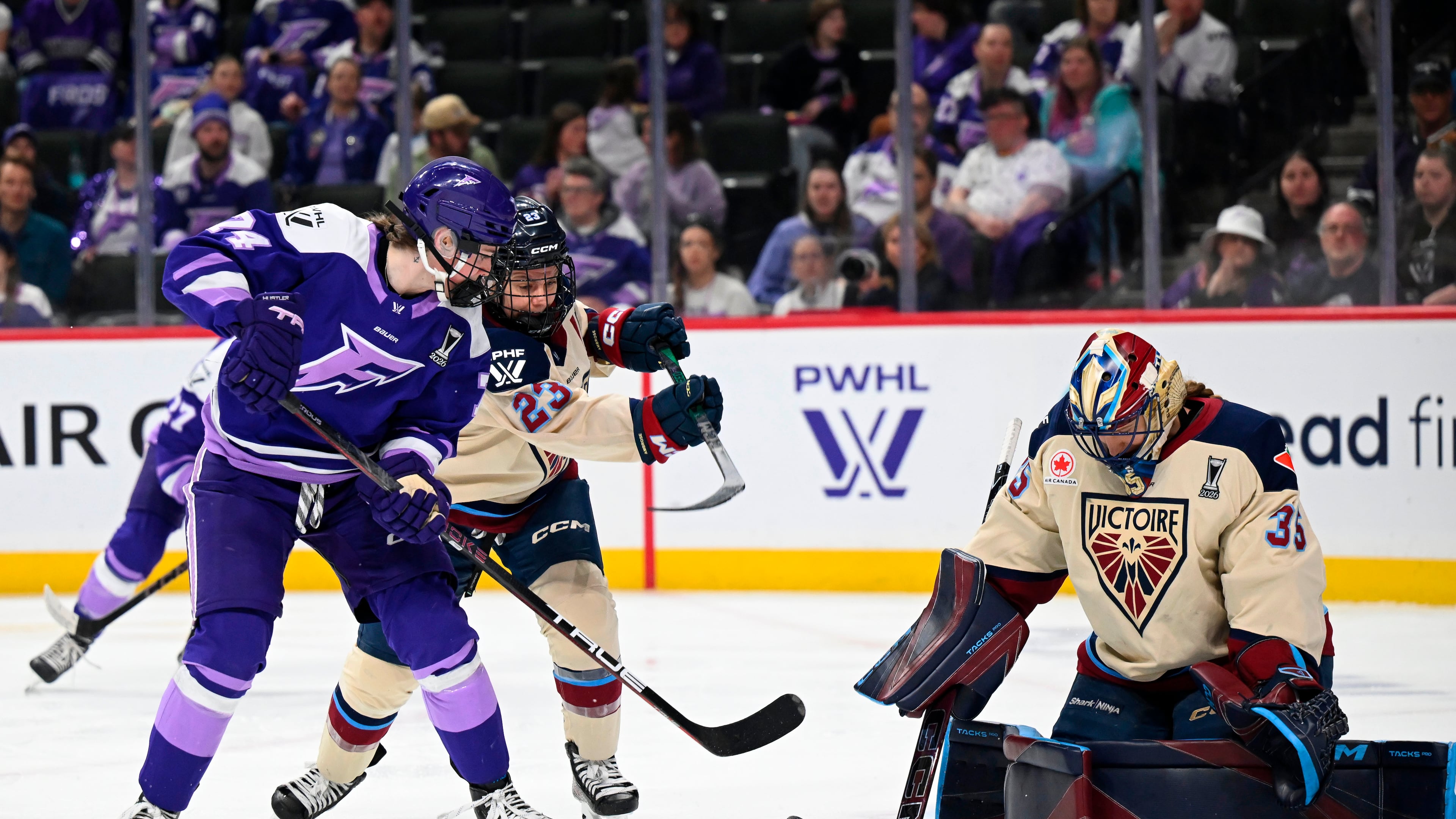 Minnesota Frost forward Abby Hustler (74) attacks the goal of Montreal Victoire goaltender Ann-Renée Desbiens (35) in the second period of a Game 4 in a PWHL hockey playoff series game, Friday, May 8, 2026, in St. Paul, Minn. (Aaron Lavinsky/Minnesota Star Tribune via AP)