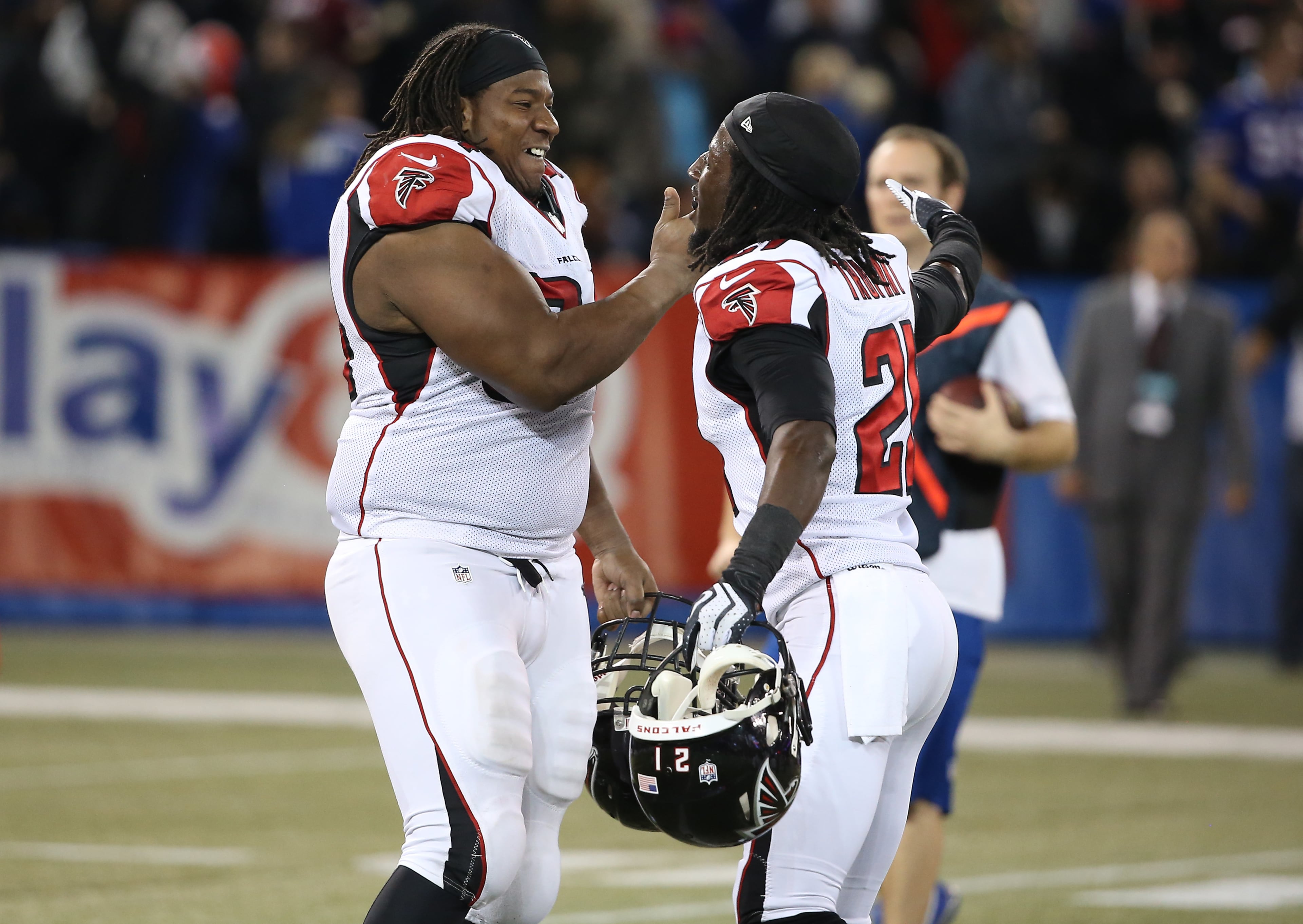 Peria Jerry #94 of the Atlanta Falcons celebrates their overtime victory with Desmond Trufant #21 during an NFL game against the Buffalo Bills at Rogers Centre.