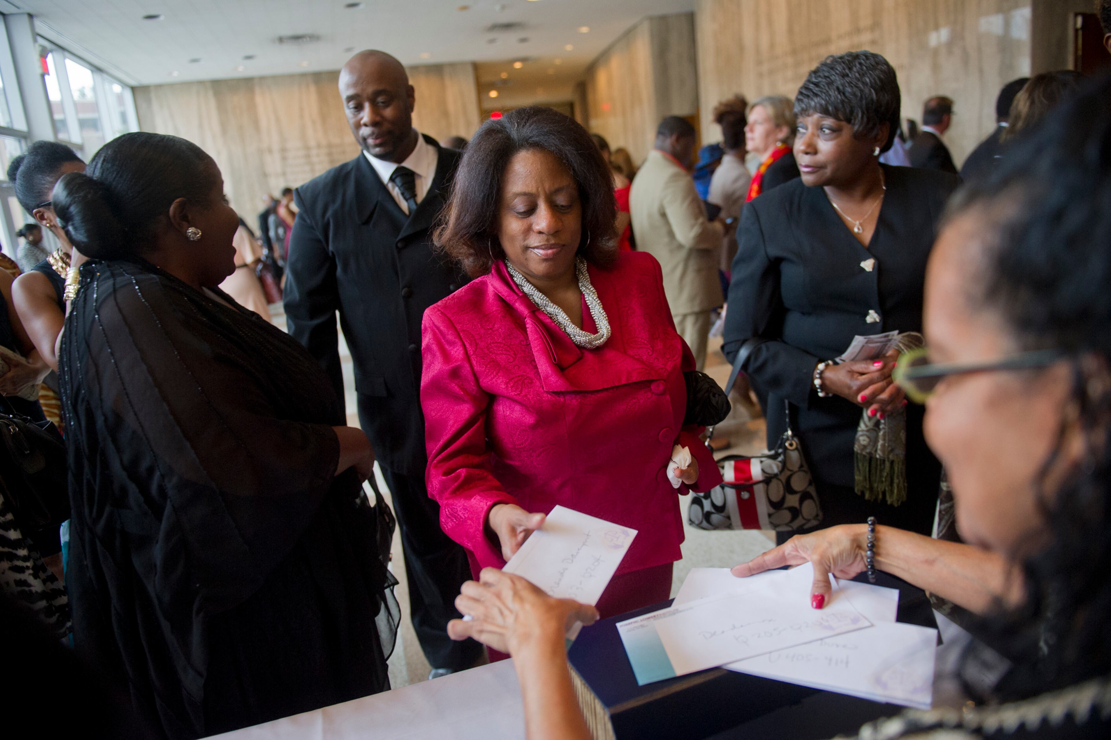 Brenda Davenport (center) picks up her ticket for I've Known Rivers: A Legendary Life, a tribute to Joseph E. Lowery's 92nd birthday celebration at Morehouse College in Atlanta on Sunday, October 6, 2013. The celebration included appearances by Tucker Malcolm Jamal Warner, Jamie Foxx, Tyler Perry and others. JONATHAN PHILLIPS / SPECIAL