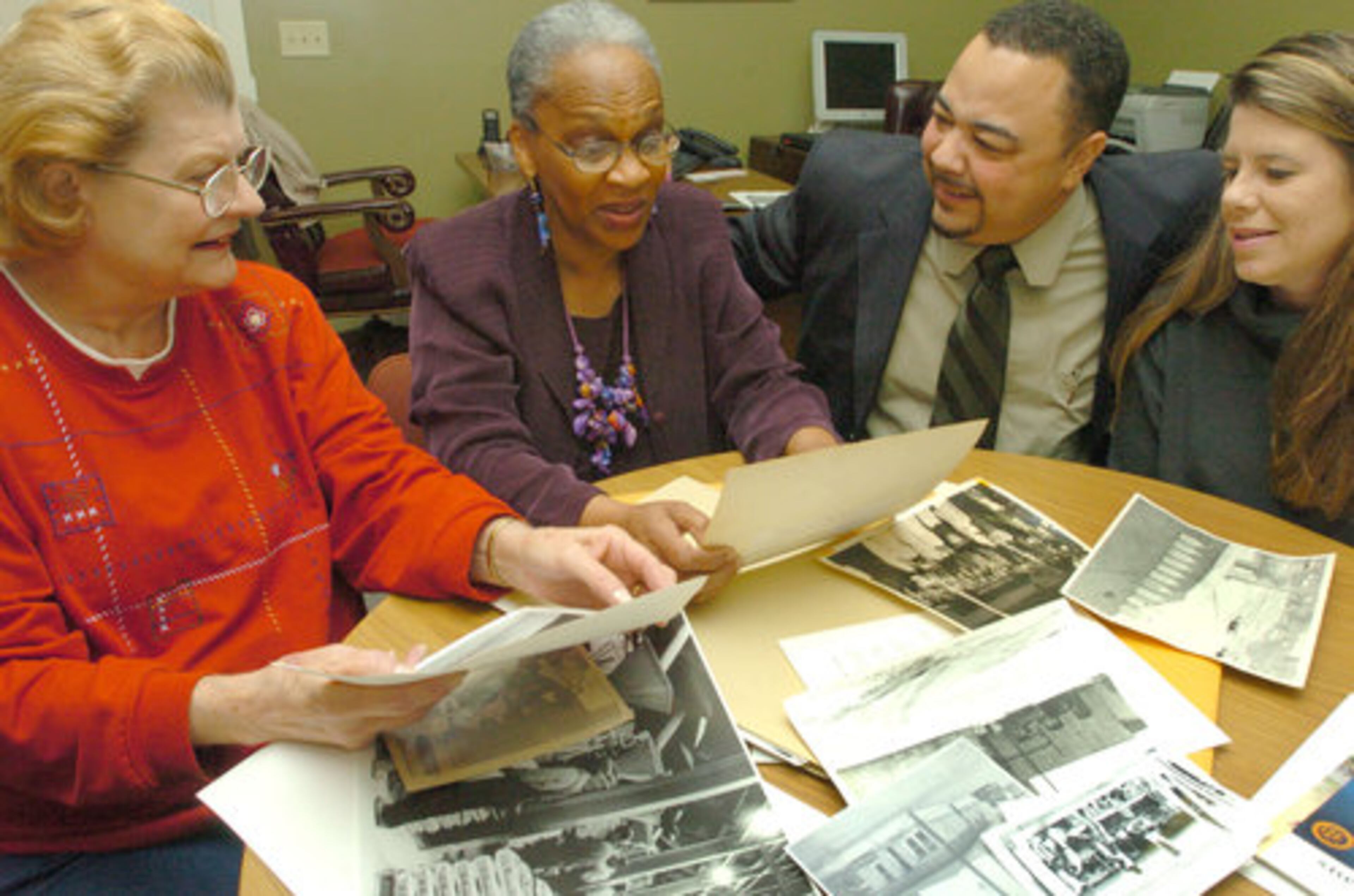 When Lithonia was planning its 150th anniversary celebration, former mayor Marcia Glenn Hunter worked with Mayor Darold Honore. Looking at historical documents in the mayor's office are (from left) Marry Ann Cowan, Marcia Glenn Hunter, Darold Honore and Kathleen deCocq.