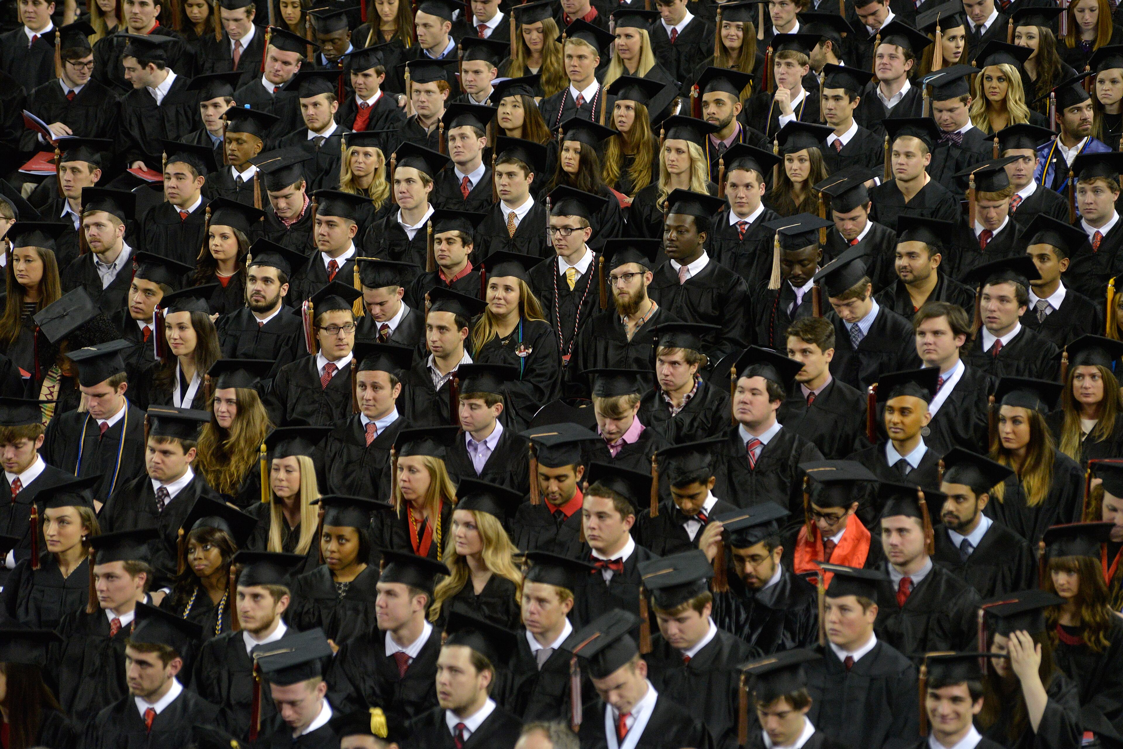 Graduating class members listens to University of Georgia President Jere Morehead speak during the university' fall undergraduate commencement ceremony at Stegeman Coliseum, Friday, Dec. 19, 2014 in Athens, Ga. (AP Photo/The Banner-Herald, Richard Hamm)