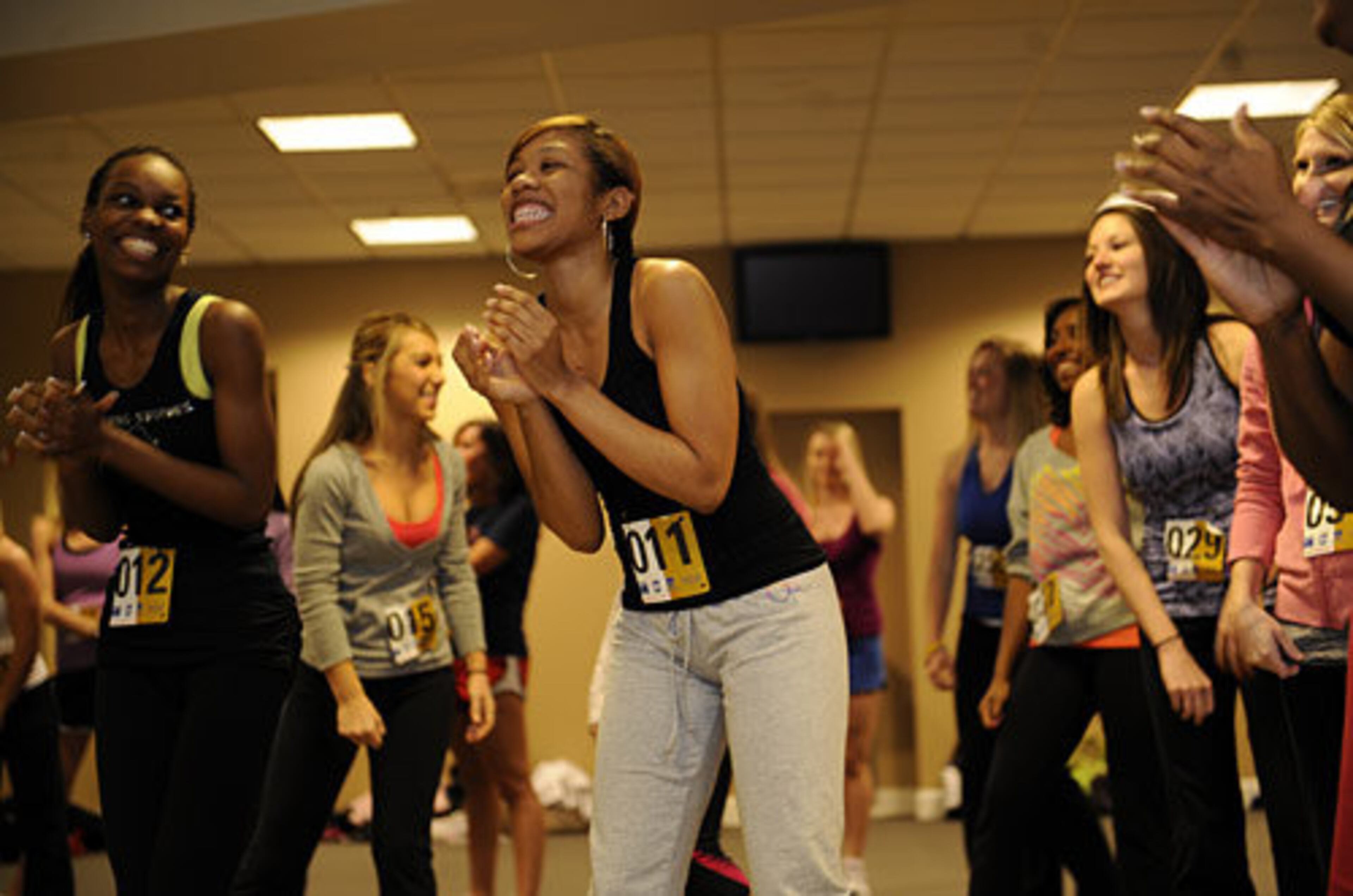 Jessica Gates, 19, of Griffin, laughs at herself after forgetting a step in a dance she is to learn as part of the Tomahawk Team auditions. The team performs a dance on top of the dugouts to "Thank God I'm a Country Boy" during each Braves home game.
