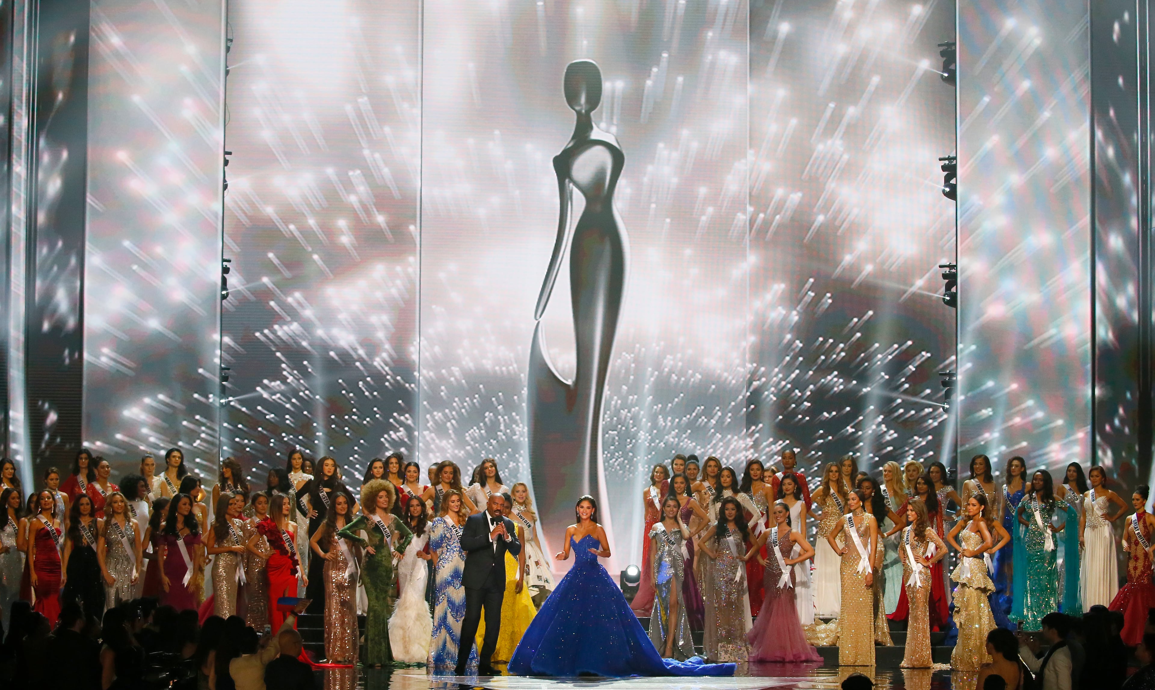 Miss Universe 2015 Pia Wurtzbach, center, bids farewell after ending her reign as the country's third Miss Universe winner during the grand coronation for the new Miss Universe Monday, Jan. 30, 2017, at the Mall of Asia in suburban Pasay city、 south of Manila, Philippines. Iris Mittenaere of France was crowned the Miss Universe 2016. (AP Photo/Bullit Marquez)