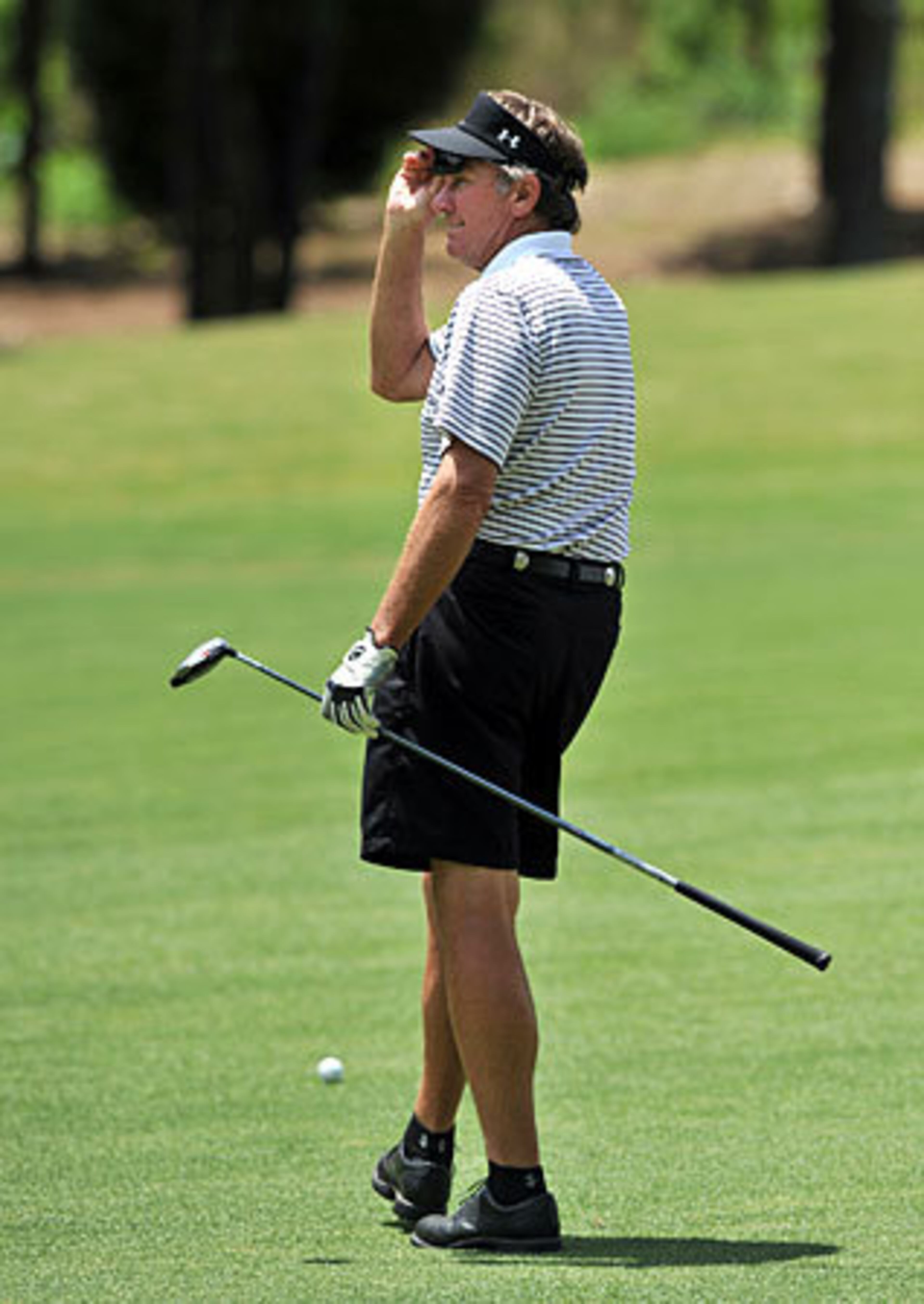 University of South Carolina head football coach Steve Spurrier lifts his sunglasses to get a better look at the green. Spurrier teamed with former Gamecock WR Sterling Sharpe to win the tournament for a second straight season.