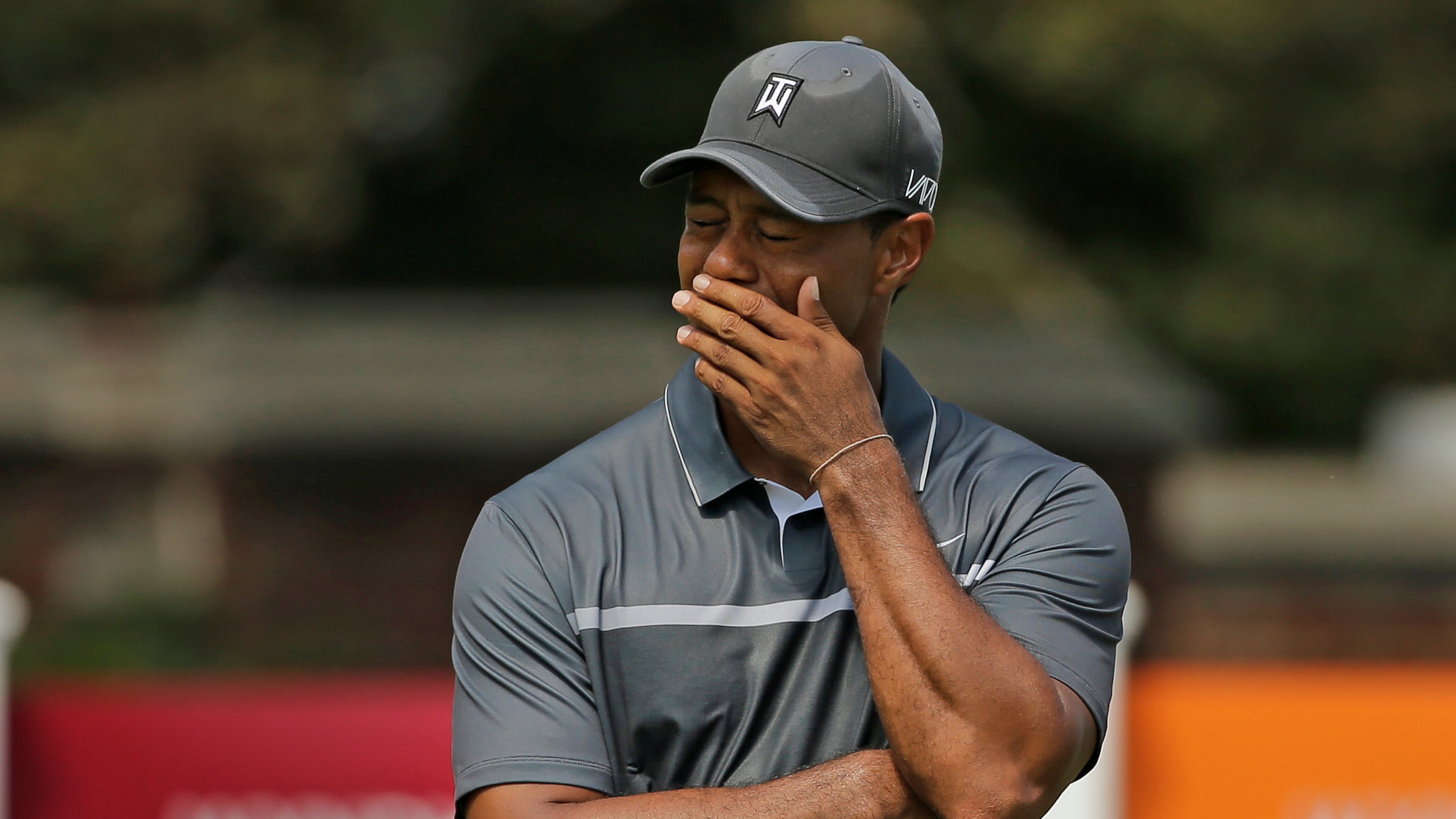 FILE - In this Aug. 21, 2015, file photo, Tiger Woods reacts after missing a putt on the ninth hole during the second round of the Wyndham Championship golf tournament in Greensboro, N.C. Tiger Woods painted a bleak picture Tuesday, Dec. 1, 2015, on when he can return to golf or even get back to doing anything more than just walking.(AP Photo/Chuck Burton)