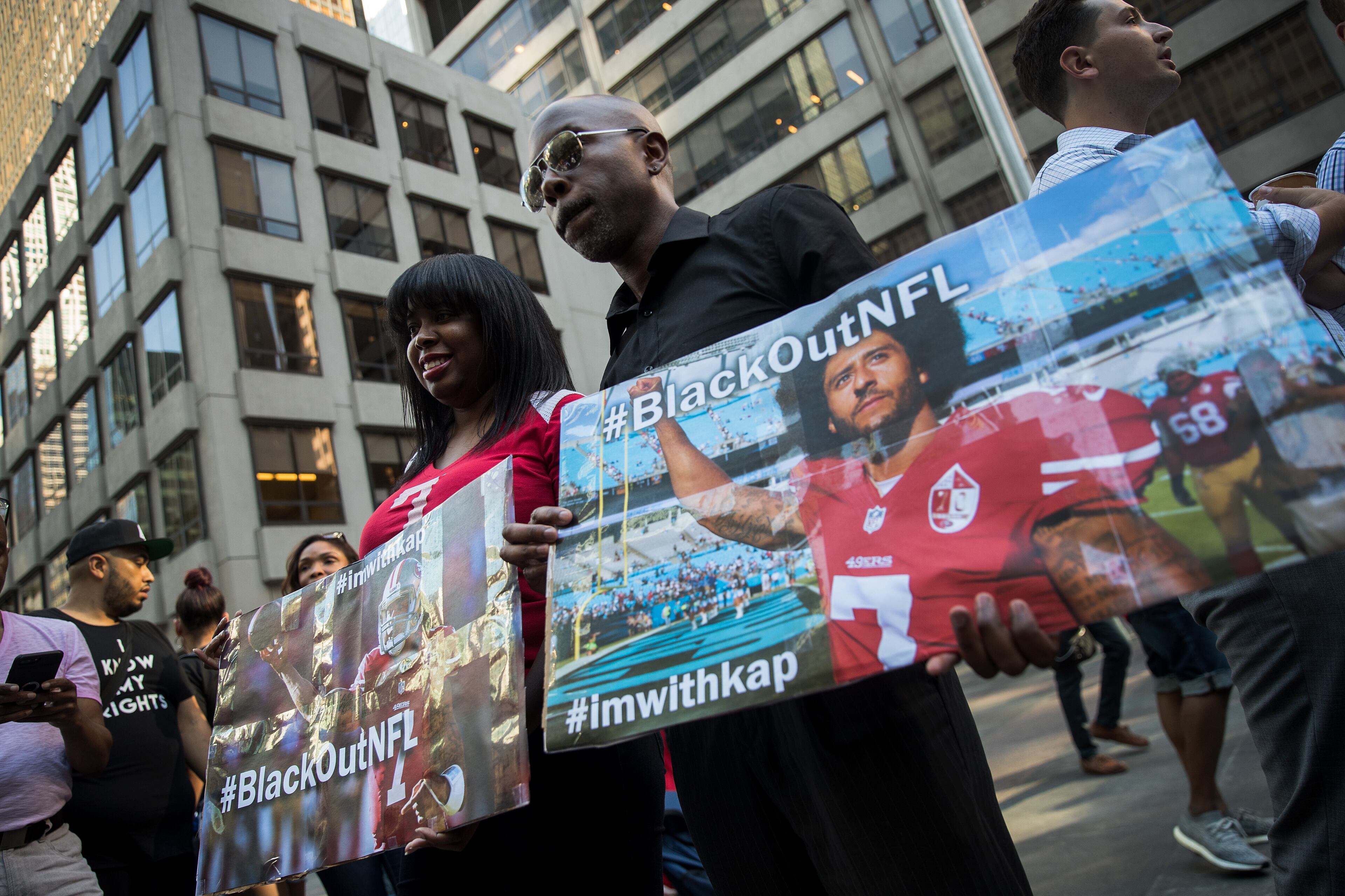 NEW YORK, NY - AUGUST 23: Activists rally in support of NFL quarterback Colin Kaepernick outside the offices of the National Football League on Park Avenue, August 23, 2017 in New York City. During the NFL season last year, Kaepernick caused controversy by kneeling during the National Anthem at games to protest racial oppression and police brutality. Kaepernick is currently a free agent and some critics and analysts claim NFL teams don't want to sign him due to his public display of his political beliefs. (Photo by Drew Angerer/Getty Images)