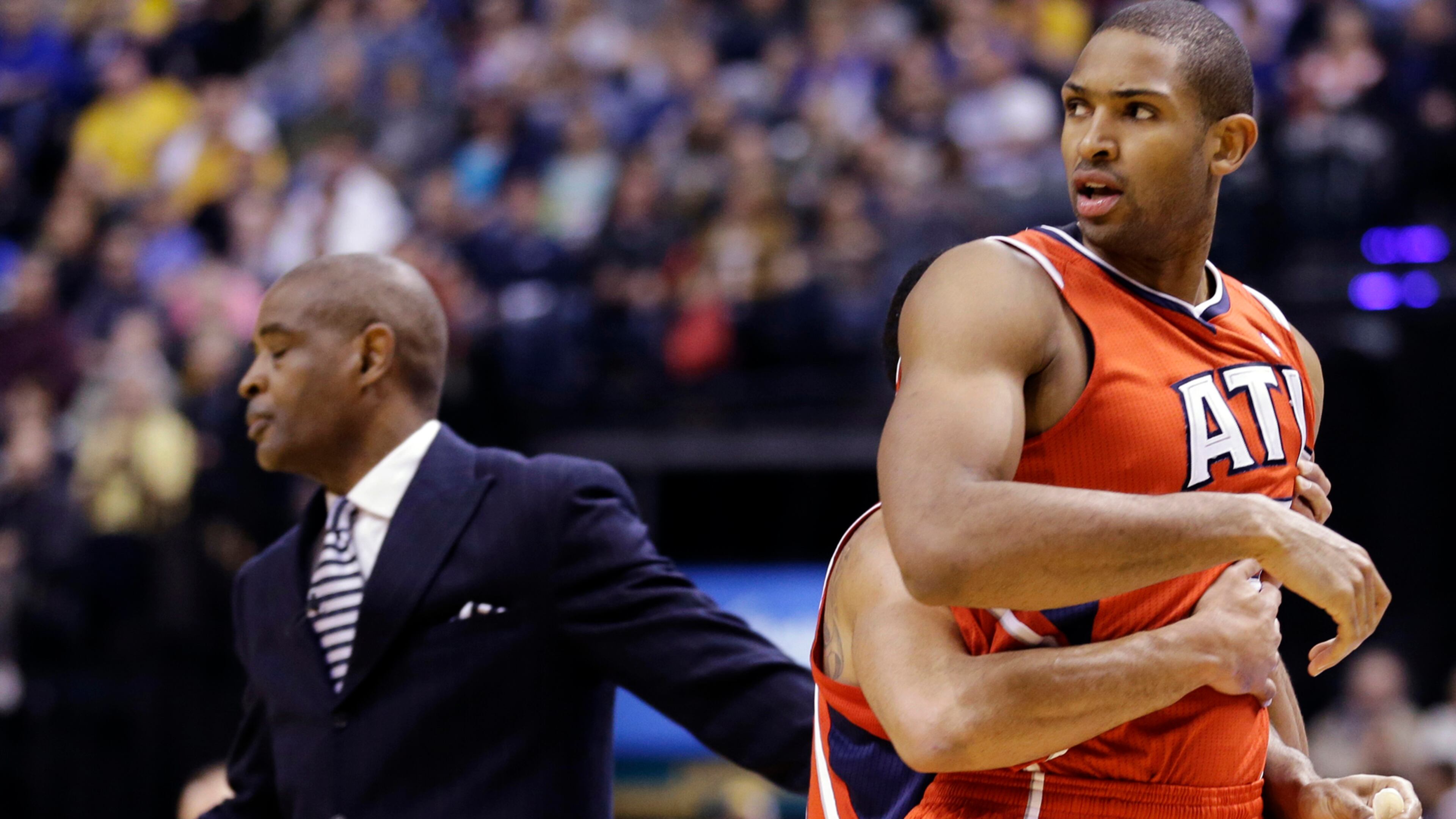 Atlanta Hawks center Al Horford, right, is restrained by teammate Devin Harris after being called for a technical foul in the first half of Game 2 of a first-round NBA basketball playoff series against the Indiana Pacers in Indianapolis, Wednesday, April 24, 2013. (AP Photo/Michael Conroy)
