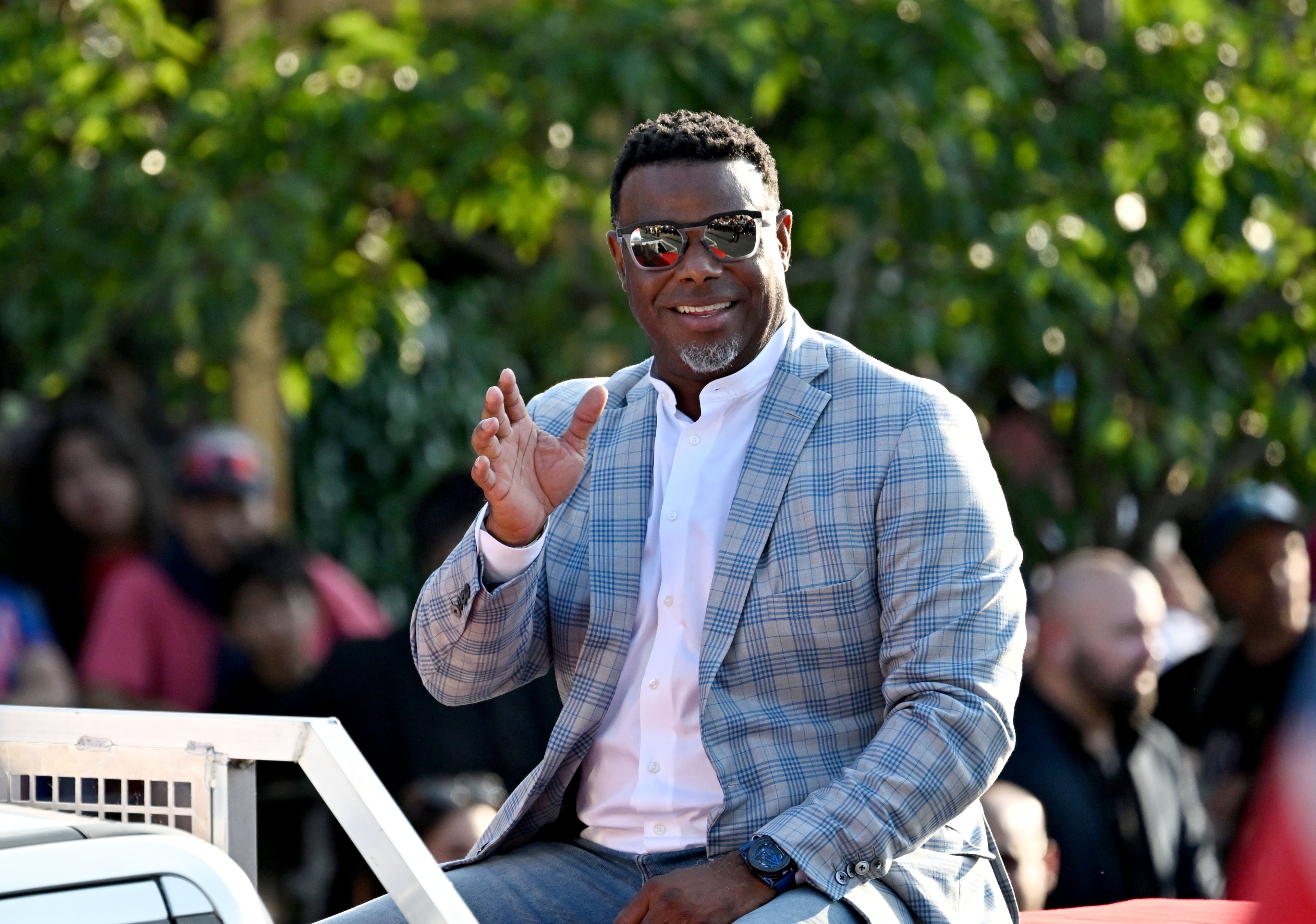 National Baseball Hall of Fame member Ken Griffey Jr. waves to spectators from the back of a pickup truck during the Hall of Fame Legends Parade on Saturday, July 25, 2026, in Cooperstown, N.Y. (Hyosub Shin/AJC)