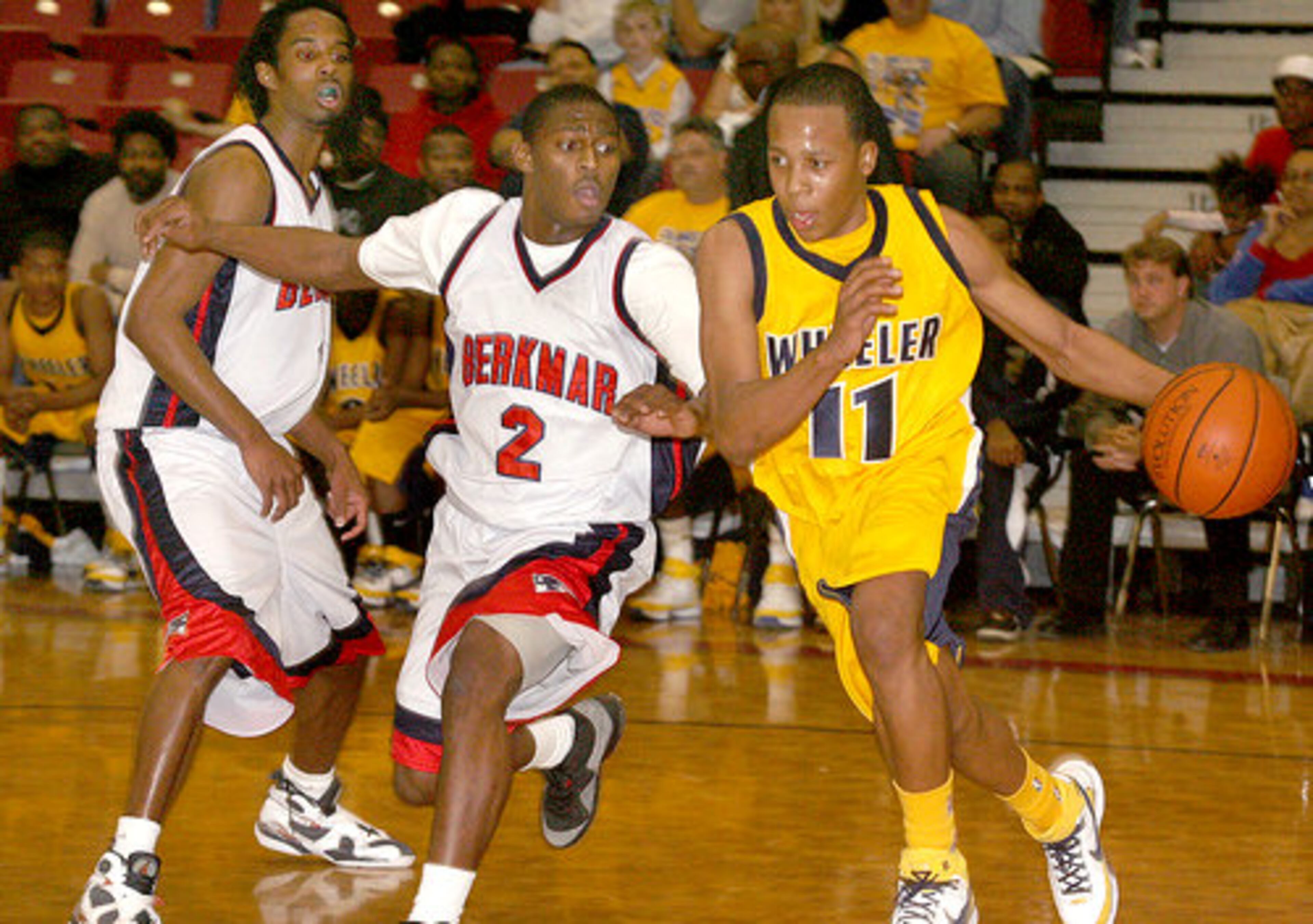Wheeler's Phil Taylor (11) tries to dribble around Berkmar's Nick Henry (2).