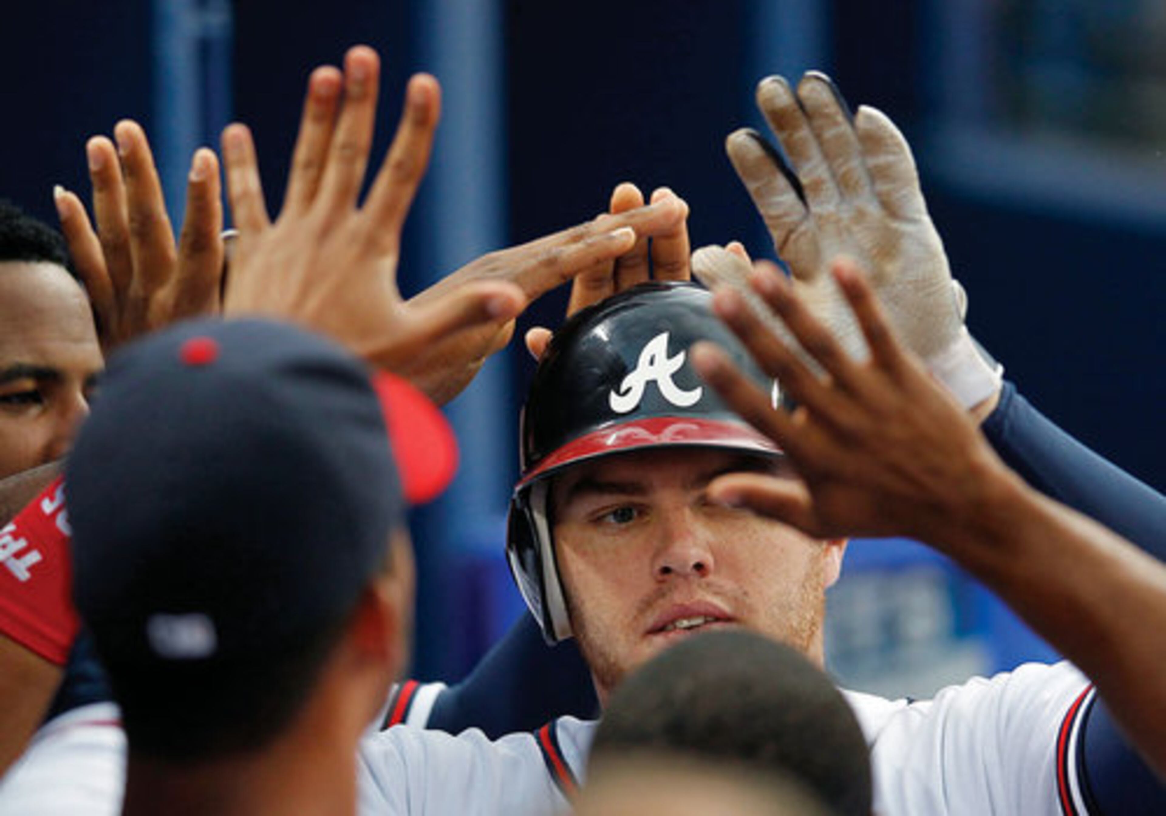 Freddie Freeman celebrates with his teammates after hitting a solo home run in the third inning.