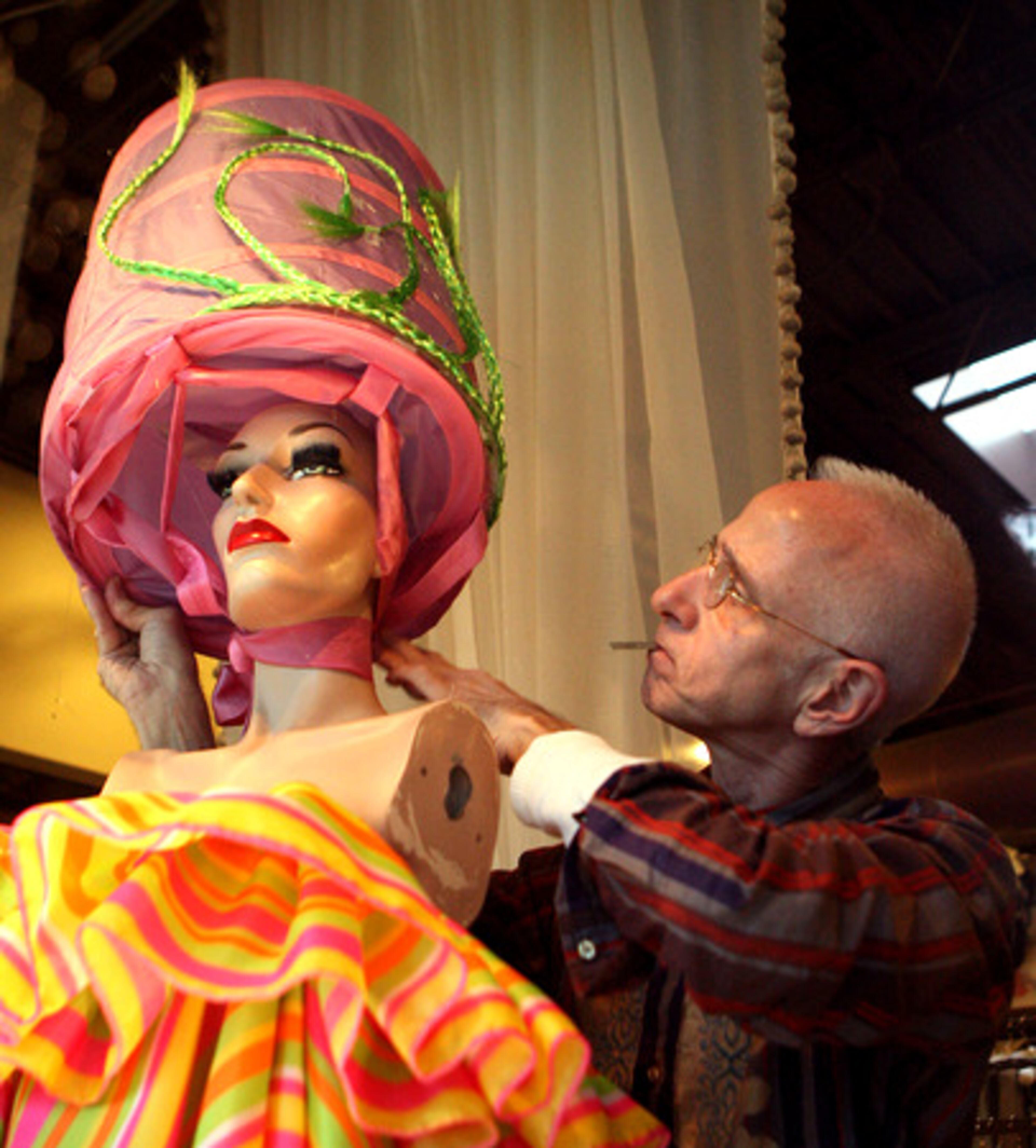 Sandy Thigpen works on his window display inside the Fine Lingerie and Vintage Couture store. Thigpen is readying the facility for spring and is known for his elaborate window displays.