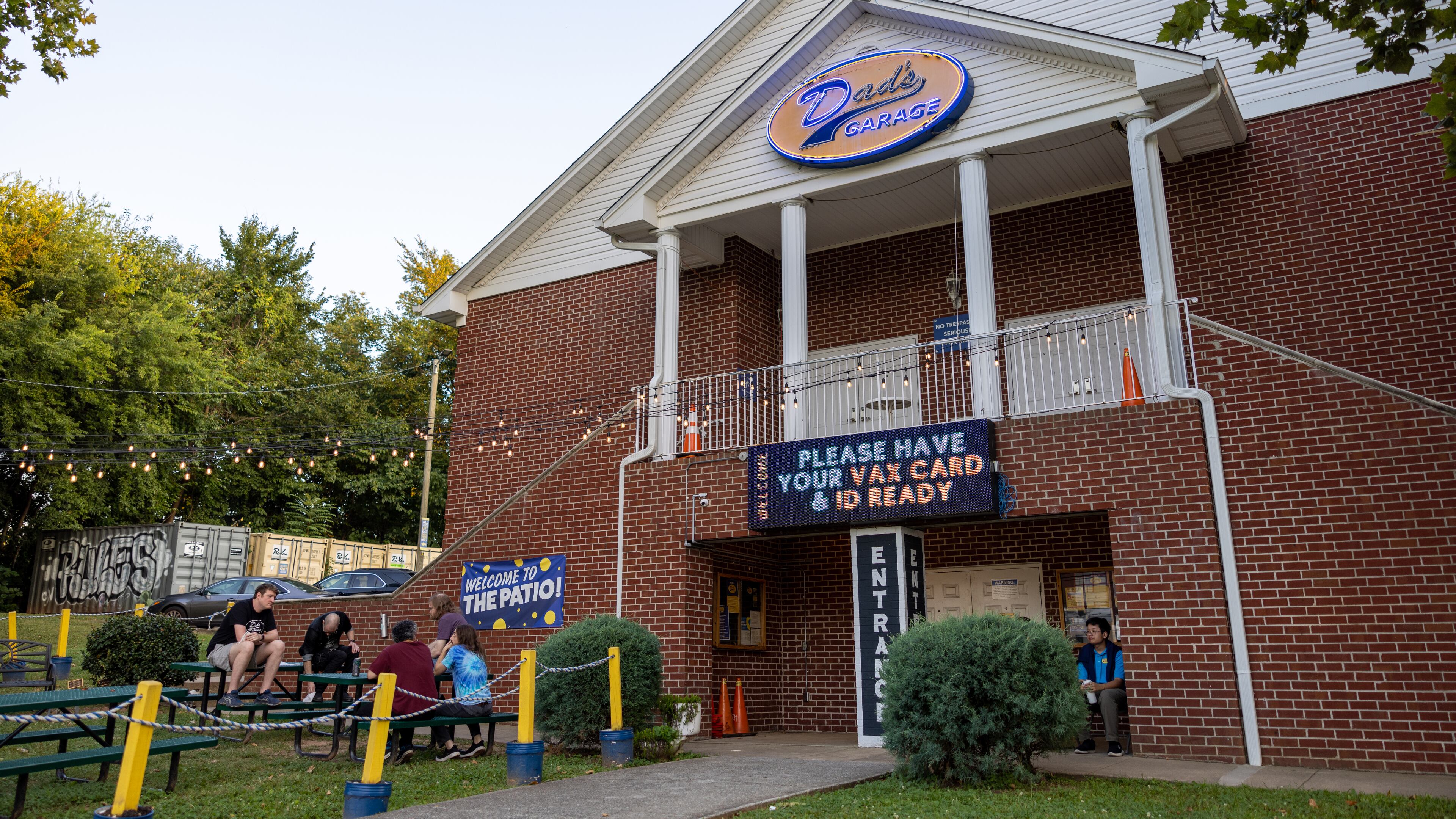 People talking on outdoor patio at Dad's Garage on September 17, 2022.