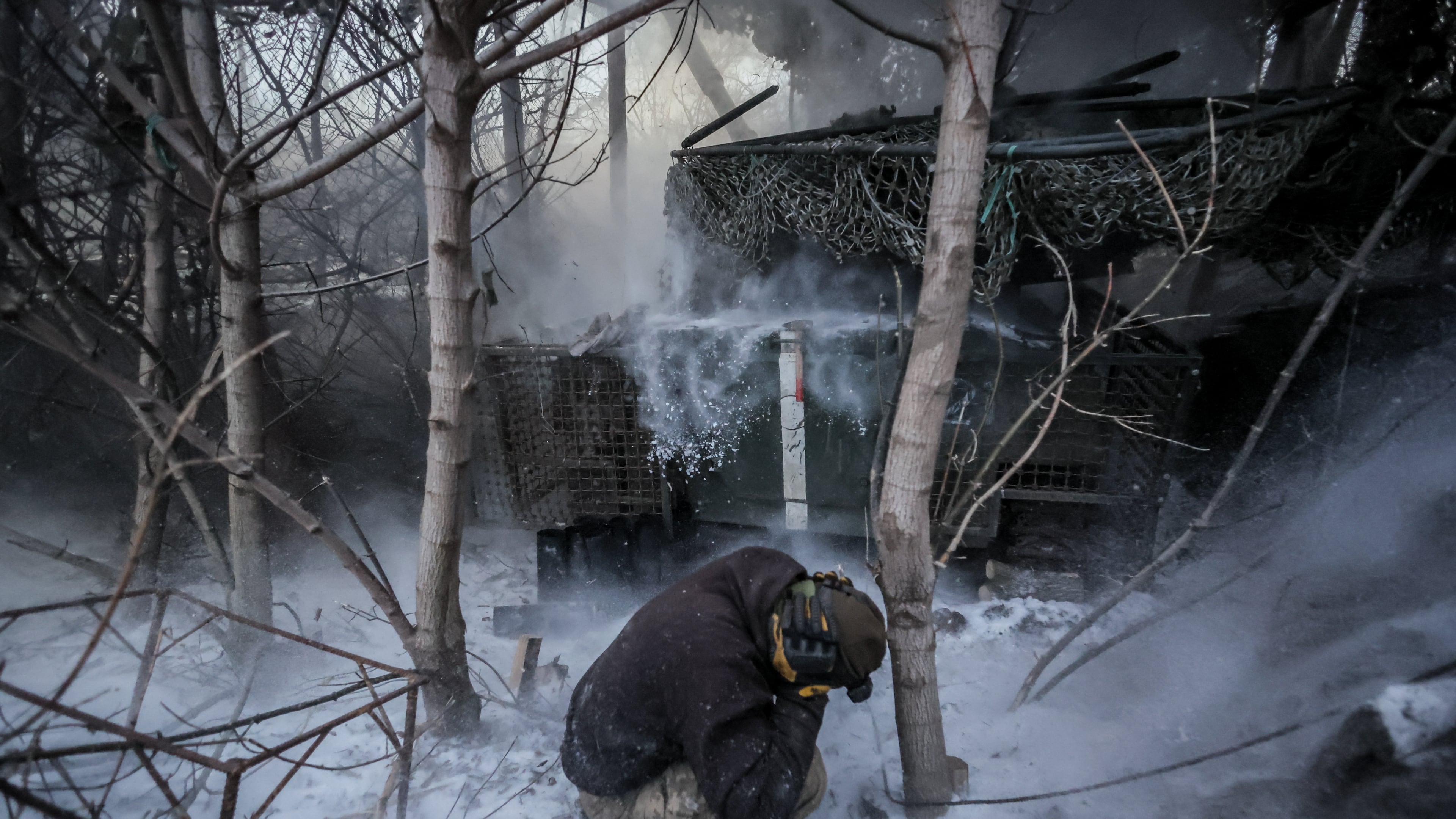 In this photo provided by Ukraine's 24th Mechanized Brigade press service, servicemen fire a 2S1 Gvozdika self propelled howitzer towards Russian positions near Chasiv Yar town, Donetsk region, Ukraine, Sunday, Jan. 18, 2026. (Oleg Petrasiuk/Ukraine's 24th Mechanized Brigade via AP)