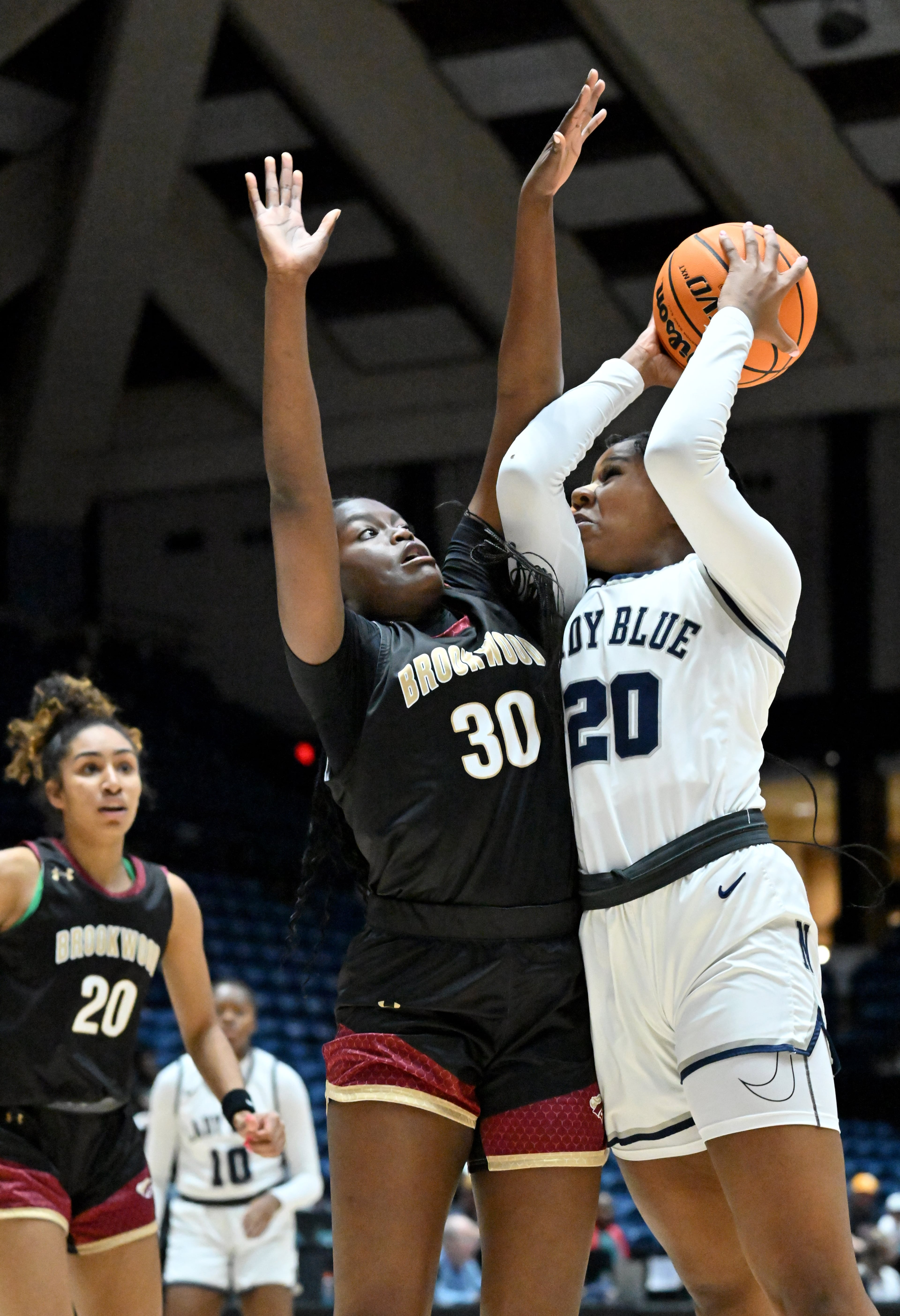 Norcross's Mariyah Valrie (20) looks to shoot against Brookwood's Danielle Osho (30). (Hyosub Shin / Hyosub.Shin@ajc.com)