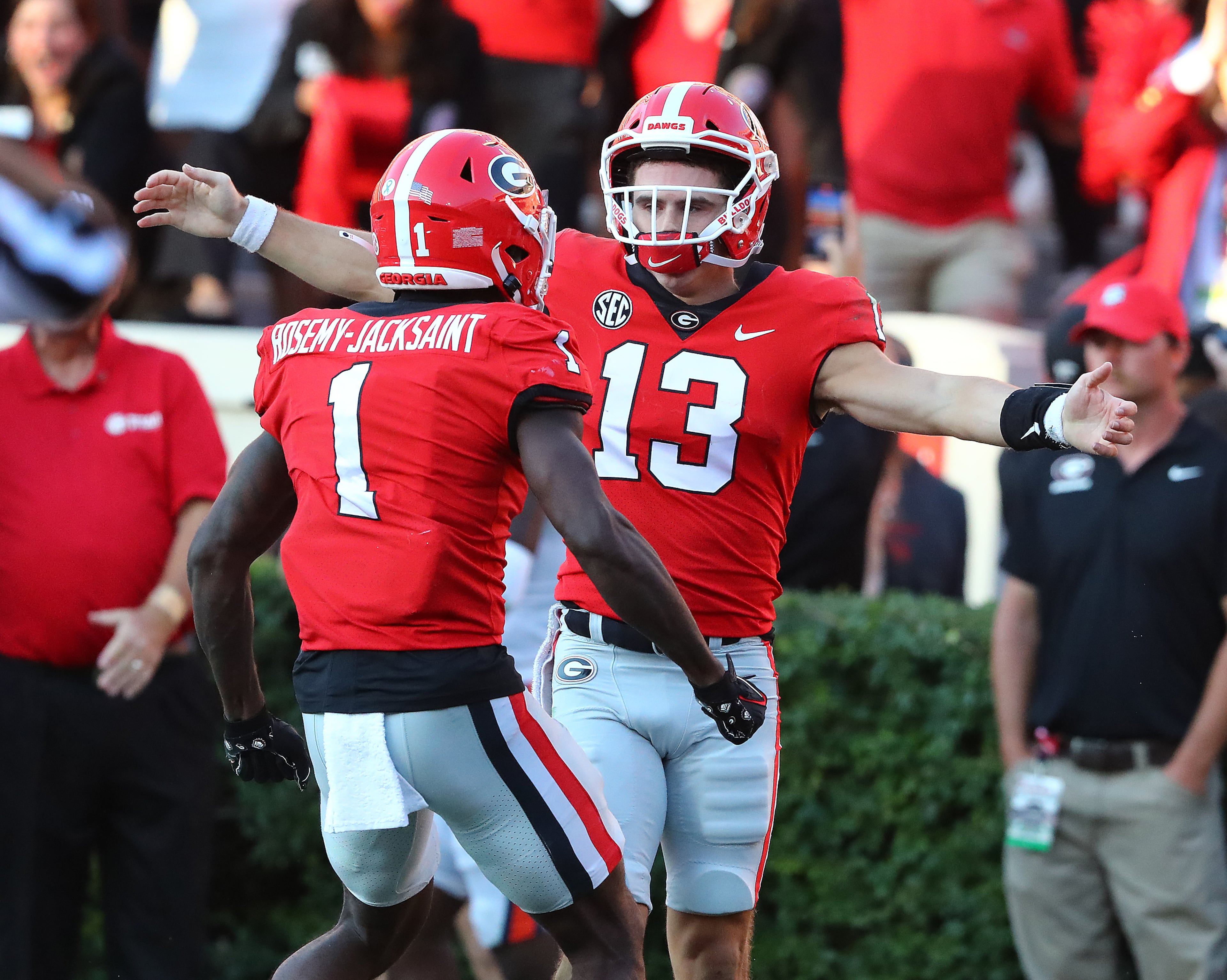 Georgia quarterback Stetson Bennett celebrates his 64-yard touchdown run, the longest of his career, with wide receiver Marcus Rosemy-Jacksaint for a 28-3 lead over Auburn during the fourth quarter in a NCAA college football game on Saturday, Oct. 8, 2022, in Athens. Curtis Compton / Curtis Compton@ajc.com