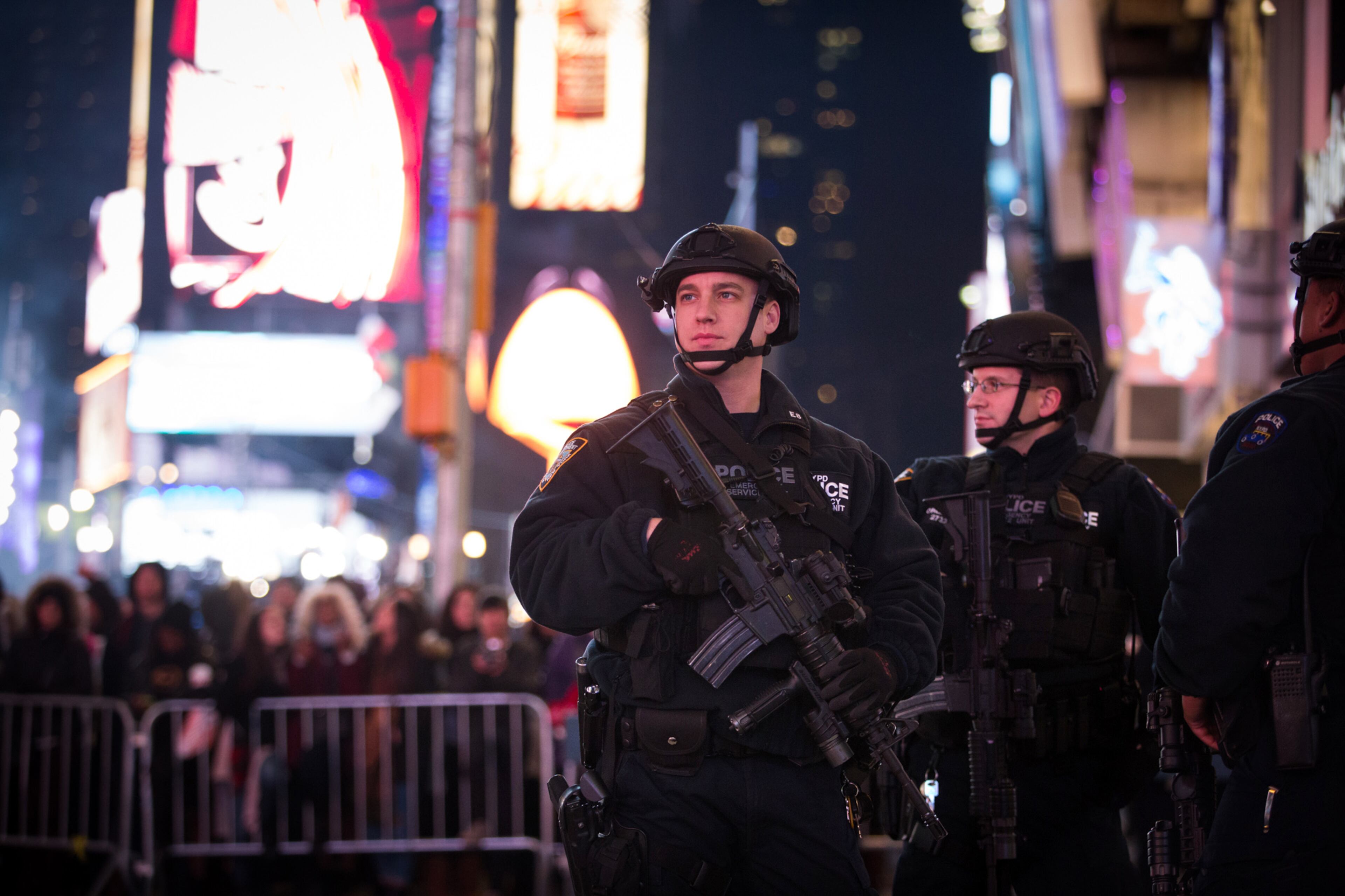 New York police officers patrol behind the barricades during the hours before the annual New Year's Eve celebration in Times Square, Thursday, Dec. 31, 2015, in New York. Nearly 6,000 armed police officers are guarding Times Square as the year 2015 draws to a close. (AP Photo/Kevin Hagen)
