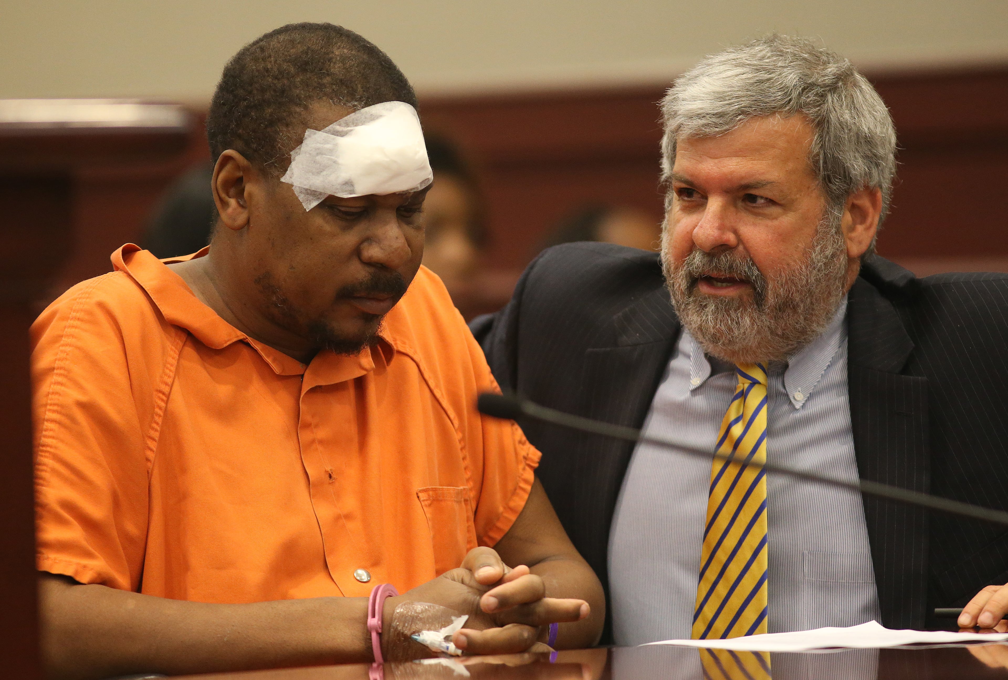 Former Hawks player Mookie Blaylock talks with his attorney Don Samuel while waiting for court to begin.