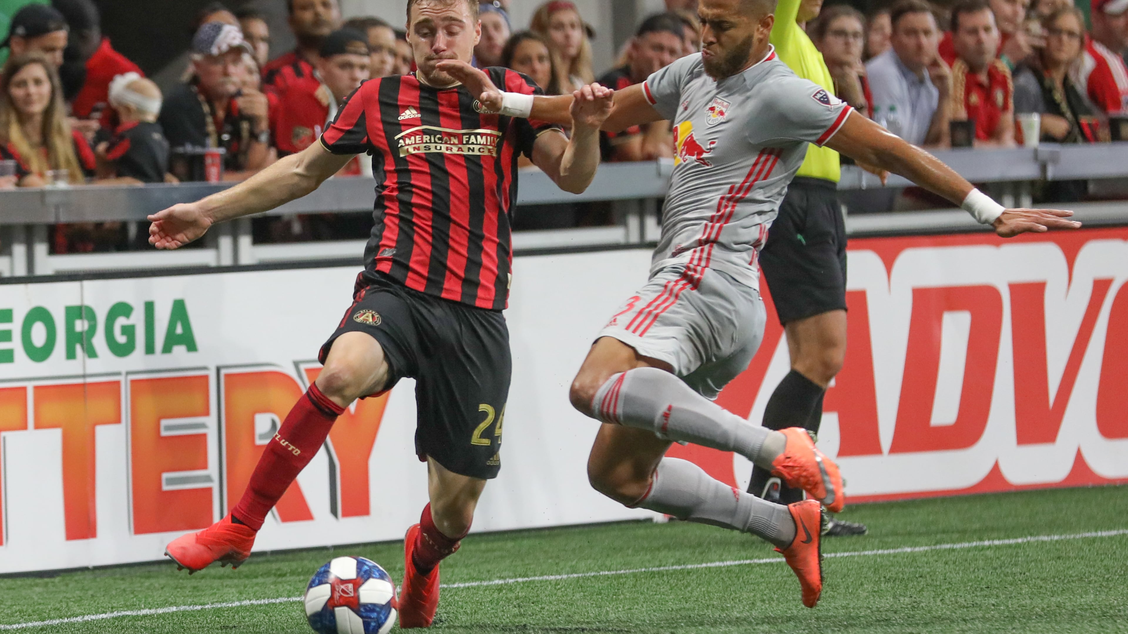 Atlanta United defender Julian Gressel (24) moves the ball past New York Red Bulls defender Amro Tarek (3) during the first half Sunday, July 7, 2019, in Atlanta.