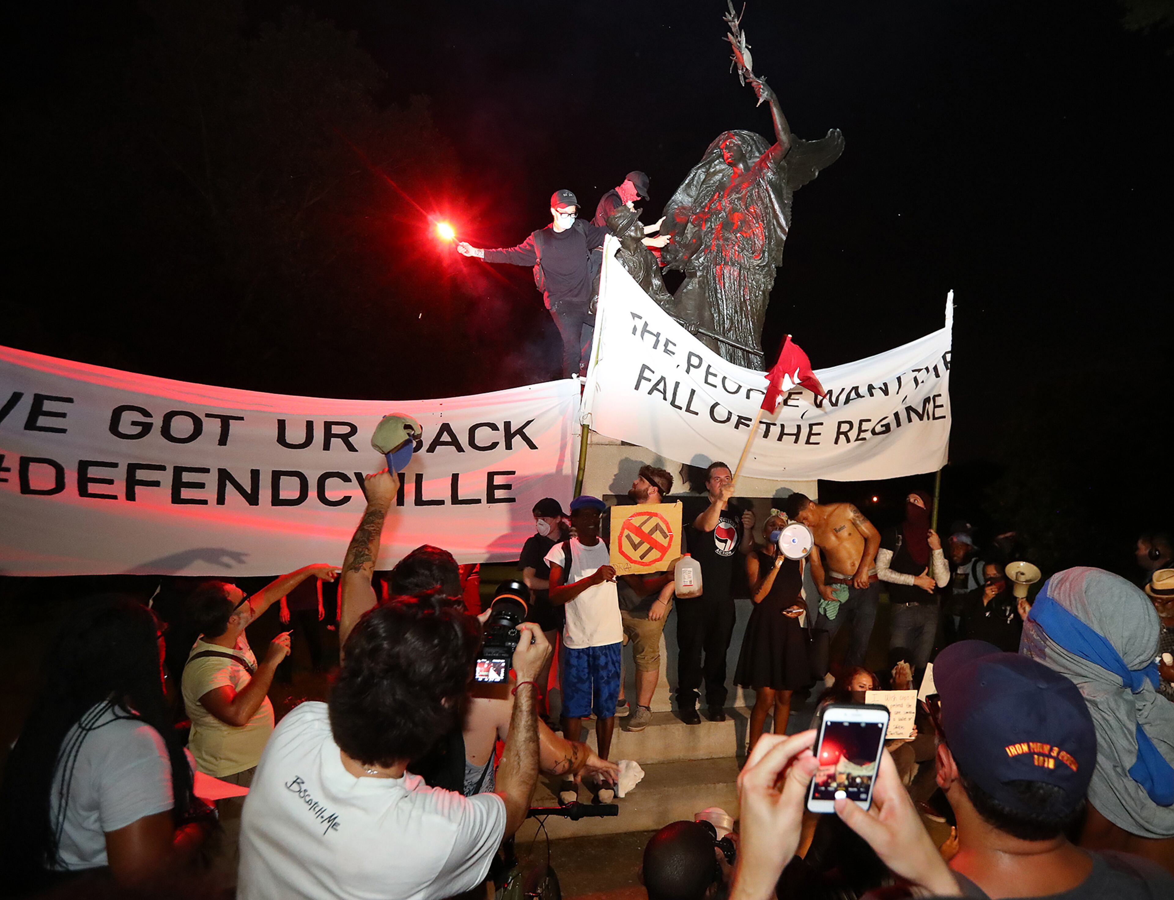 Protesters climbed the Peace Monument in Piedmont Park, spray painted it and tried tearing it down. The structure was erected in 1911 to champion unity and reconciliation. AJC photo: Curtis Compton