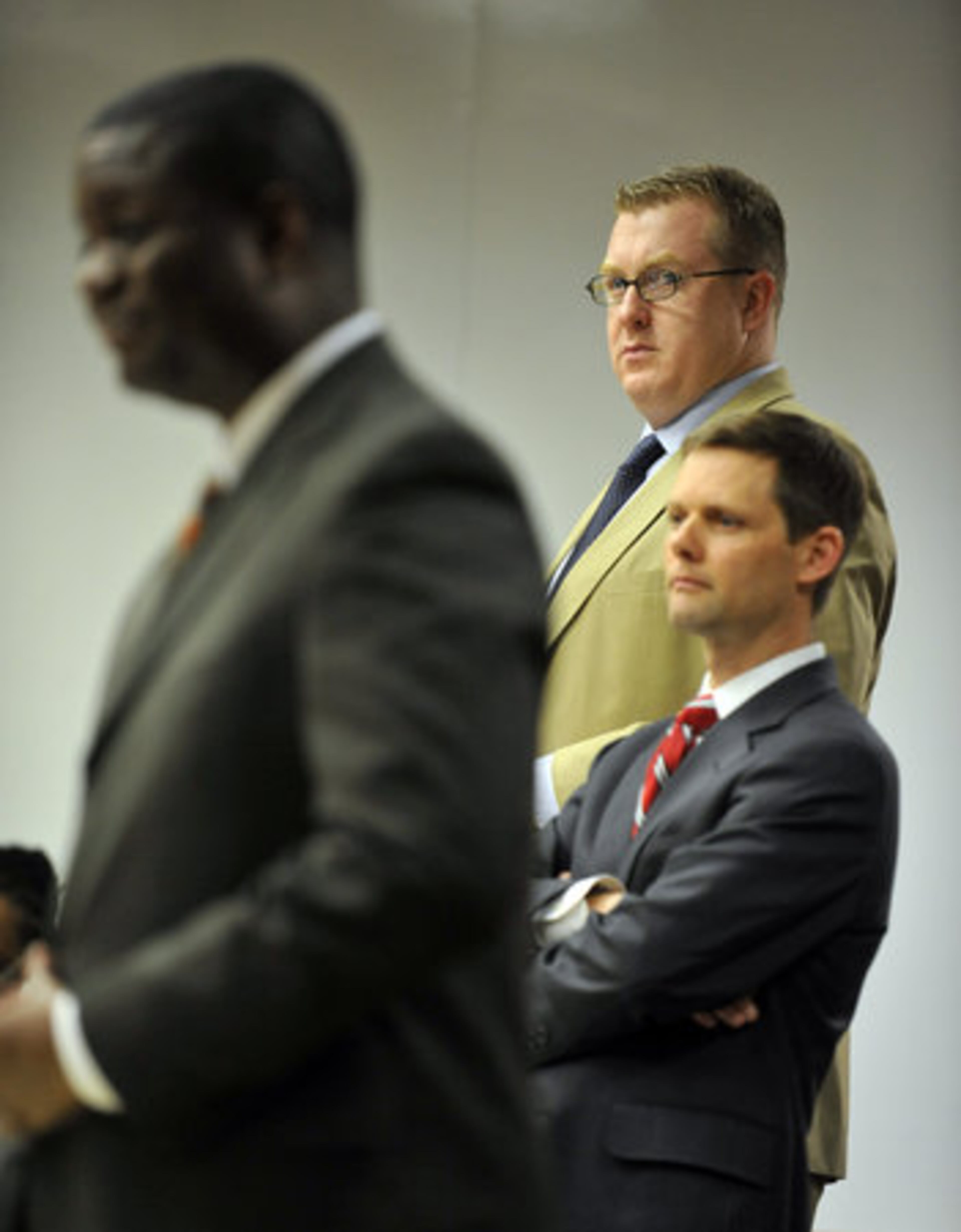 Former Marietta High School teacher, Christopher King , back, defense attorney Scott Semrau, middle, and prosecutor Maurice Brown, foreground, stand as the jury enters the courtroom.