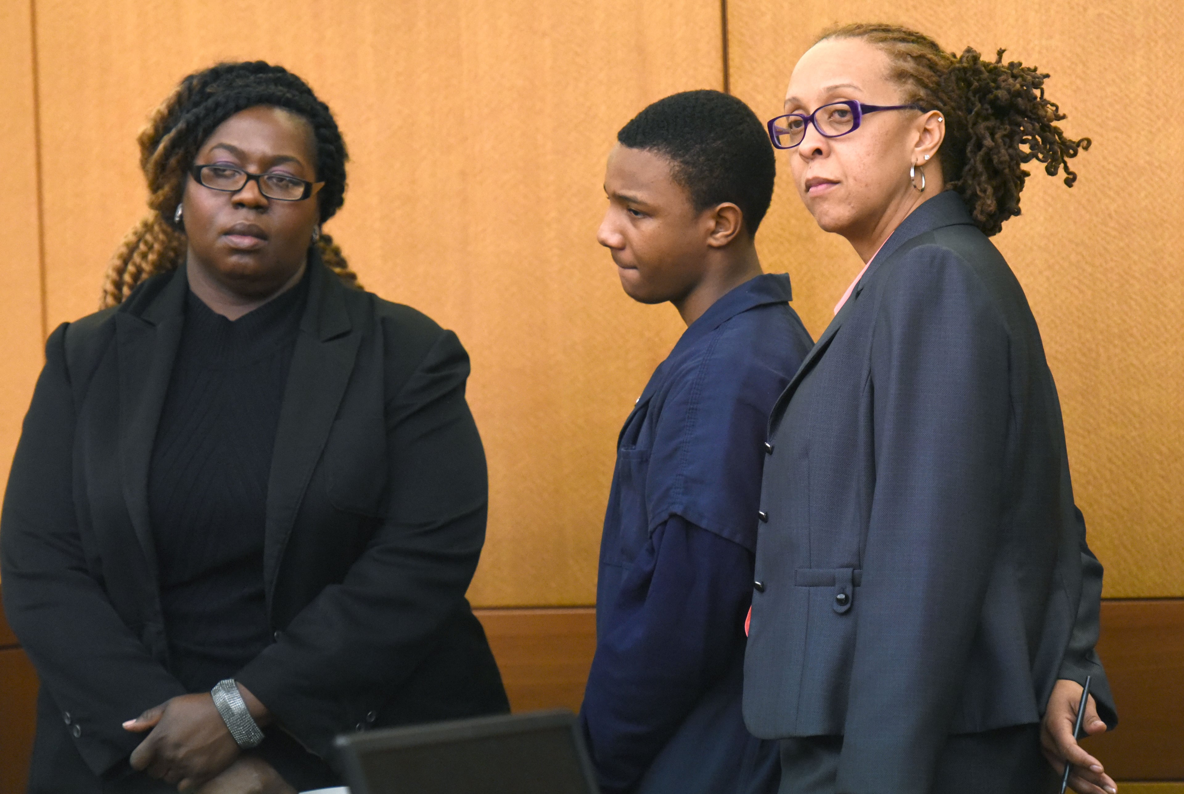 Quindarius Slade, 15, stands with his attorney at Fulton County Superior Court on Thursday, Jan. 28, 2016. He pleaded guilty in a home invasion case and was sentenced to 18 years in prison. HYOSUB SHIN / HSHIN@AJC.COM